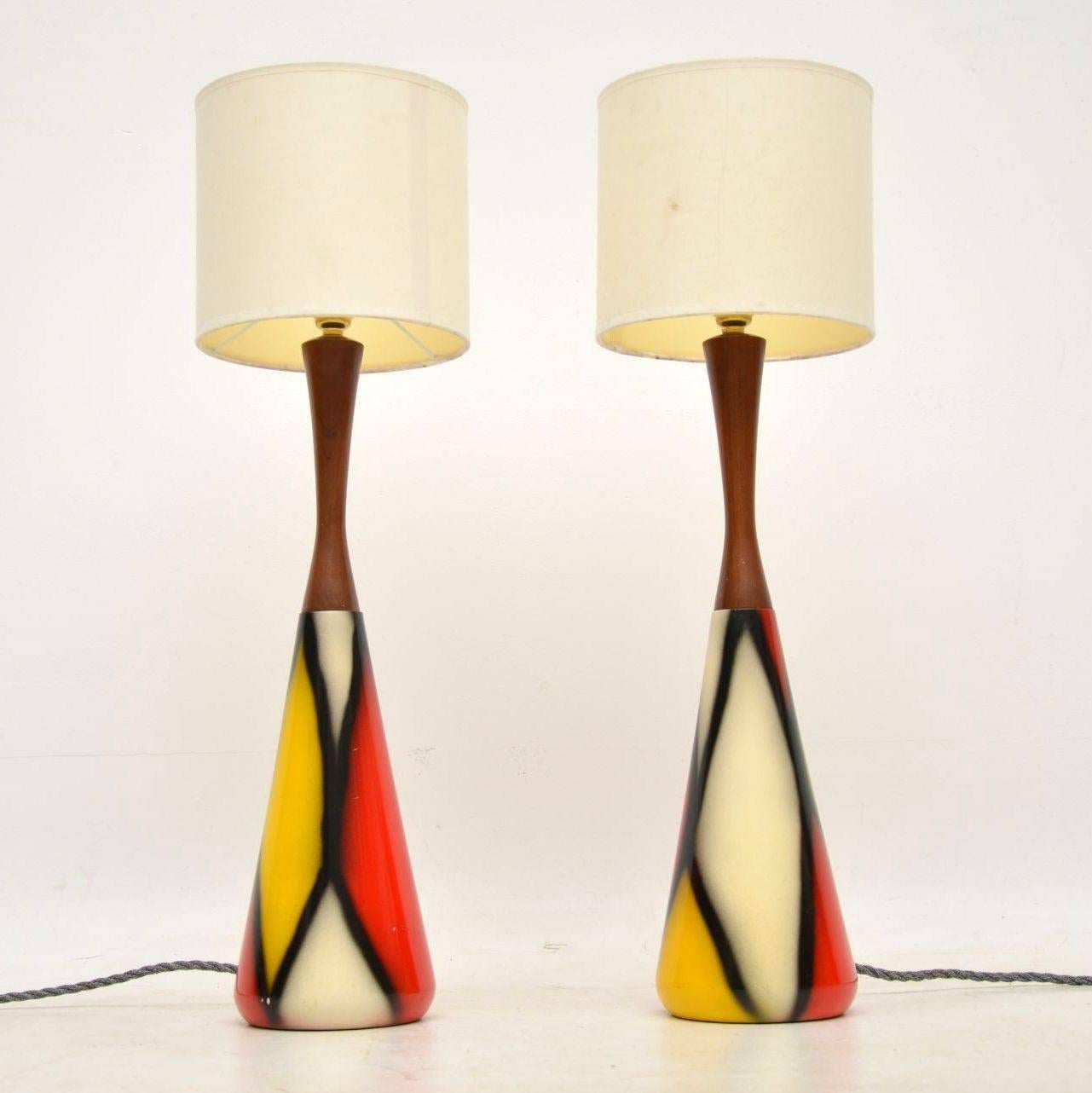 A superb pair of vintage table lamps, these date from the 1960s. They have a beautiful conical design, the colourful part is made from some sort of resin, with solid teak tops. They are in excellent condition, we have had them newly re-wired and PAT