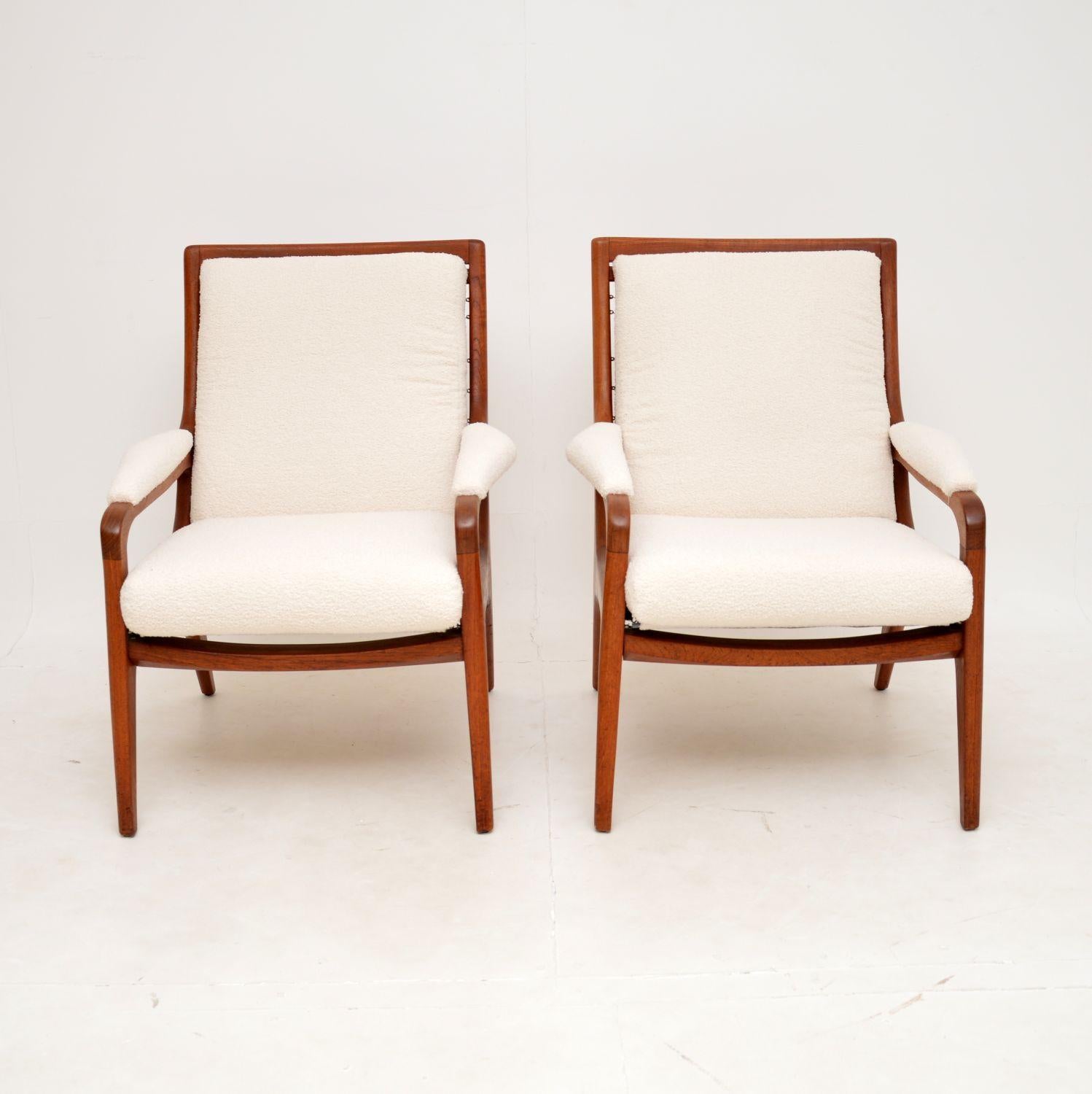 A very stylish and extremely well made pair of vintage solid teak armchairs. They were made in England by Howard Keith, they date from around the 1960’s.

They have a beautiful, sweeping design and are of amazing quality. The whole frame is sprung