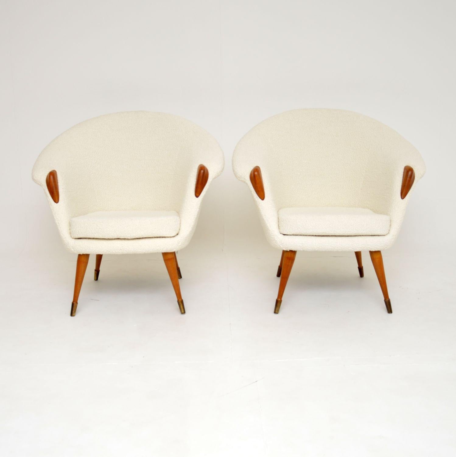An absolutely stunning pair of vintage armchairs. They were made in England and date from the 1960’s.

The quality is excellent and the design is gorgeous. They have wide curved frames, with teak paws on the arms and teak tapered legs, the legs