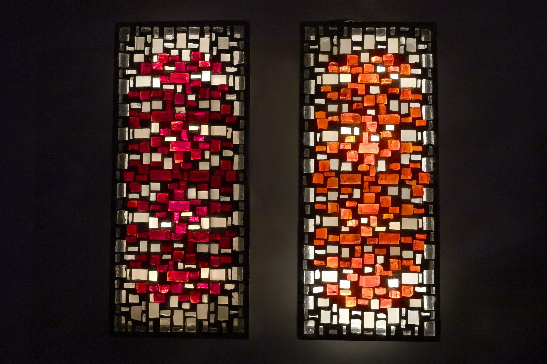 Pair of wall appliques with inset colorless and bumped red and orange glass stones, and satin glass stones.
Rectangular cement cast plates in which the glass artist has arranged these glass stones.
They are provided with power outlets and equipped