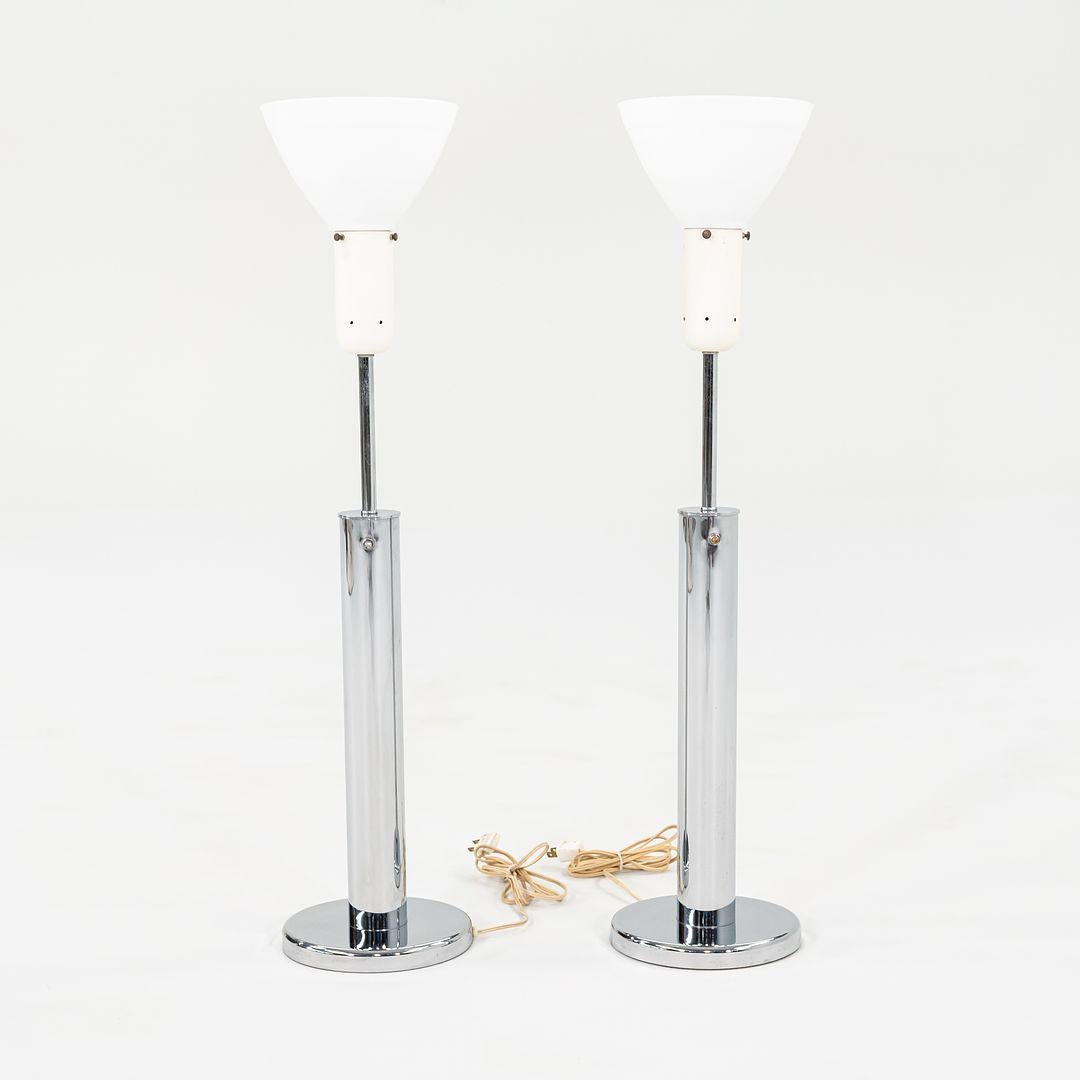This is a pair of Modernist Cylindrical Table Lamps, designed by Walter Von Nessen for Nessen Studios in the late 1960s. The bodies of the lamps sport a straightforward yet striking design, and retain their original white glass diffuser shades. One