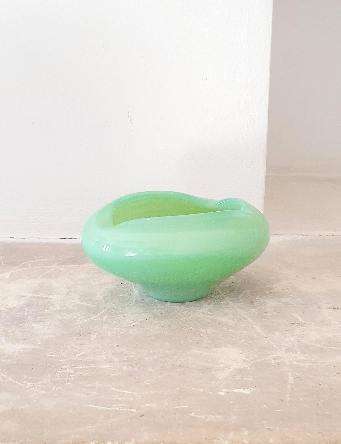 A delightful opaque milky pale green murano glass bowl perfect for coffee table or mantlepiece. This bowl has an organic shape, is an exceptional colour and is in very good condition.

Dimensions: H9cm X W16cm X D13cm