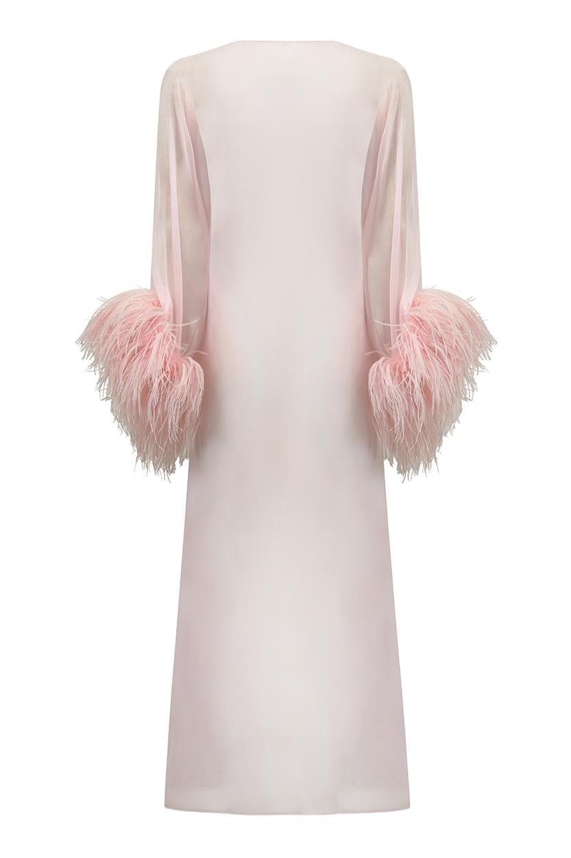 This gorgeous 1960s sugar pink chiffon peignoir gown features luxurious ostrich feather trim on the cuffs and simply oozes opulence and daring. The gown is entirely sheer and designed to be loose fitting. It fastens across the centre bust with a