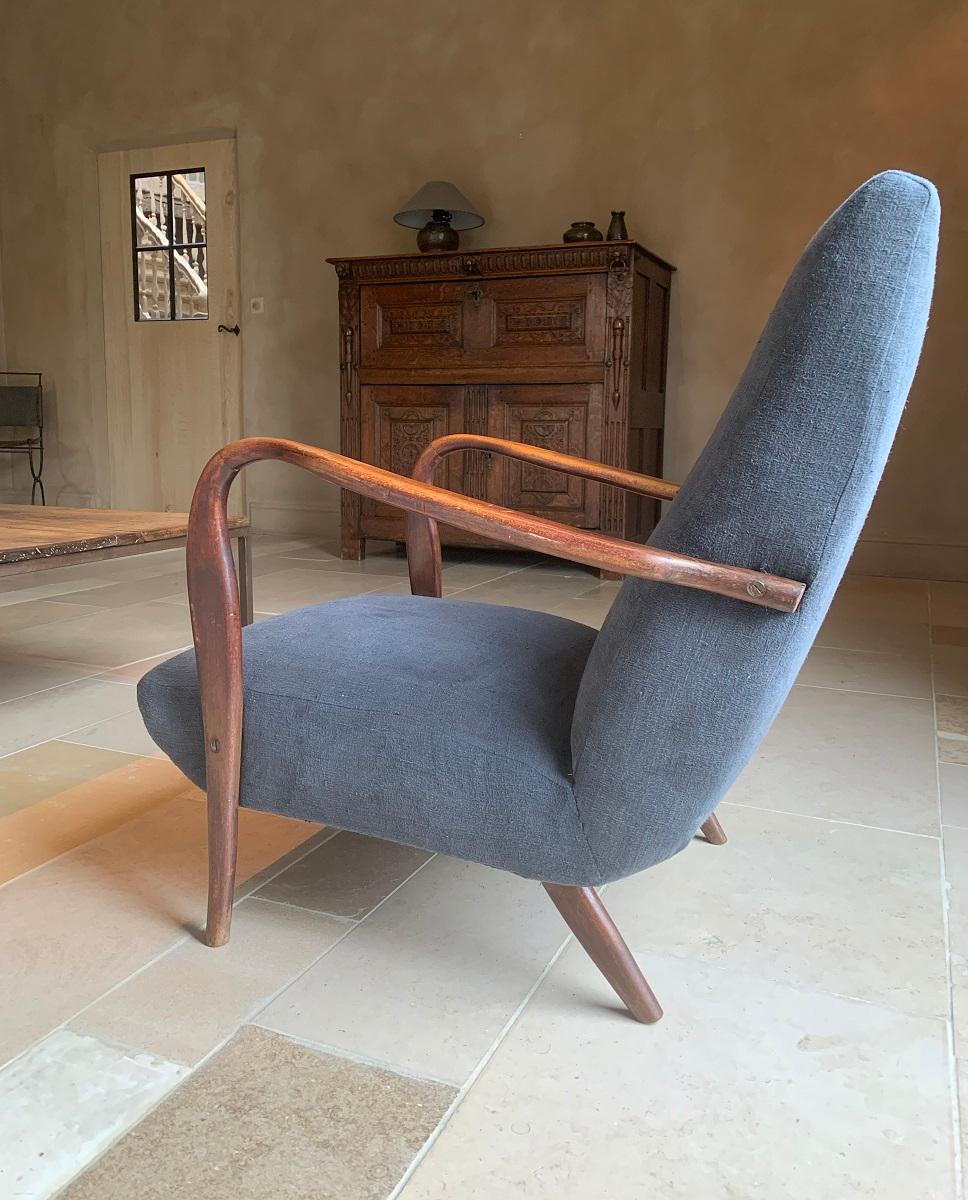 A 1960s Paola Buffa style lounge chair. Elegant lines in beech reupholstered with vintage French linen. This cosy seat is very sturdy and comfortable. We preserved its patina but reinforced its structure so it's ready for everyday use.