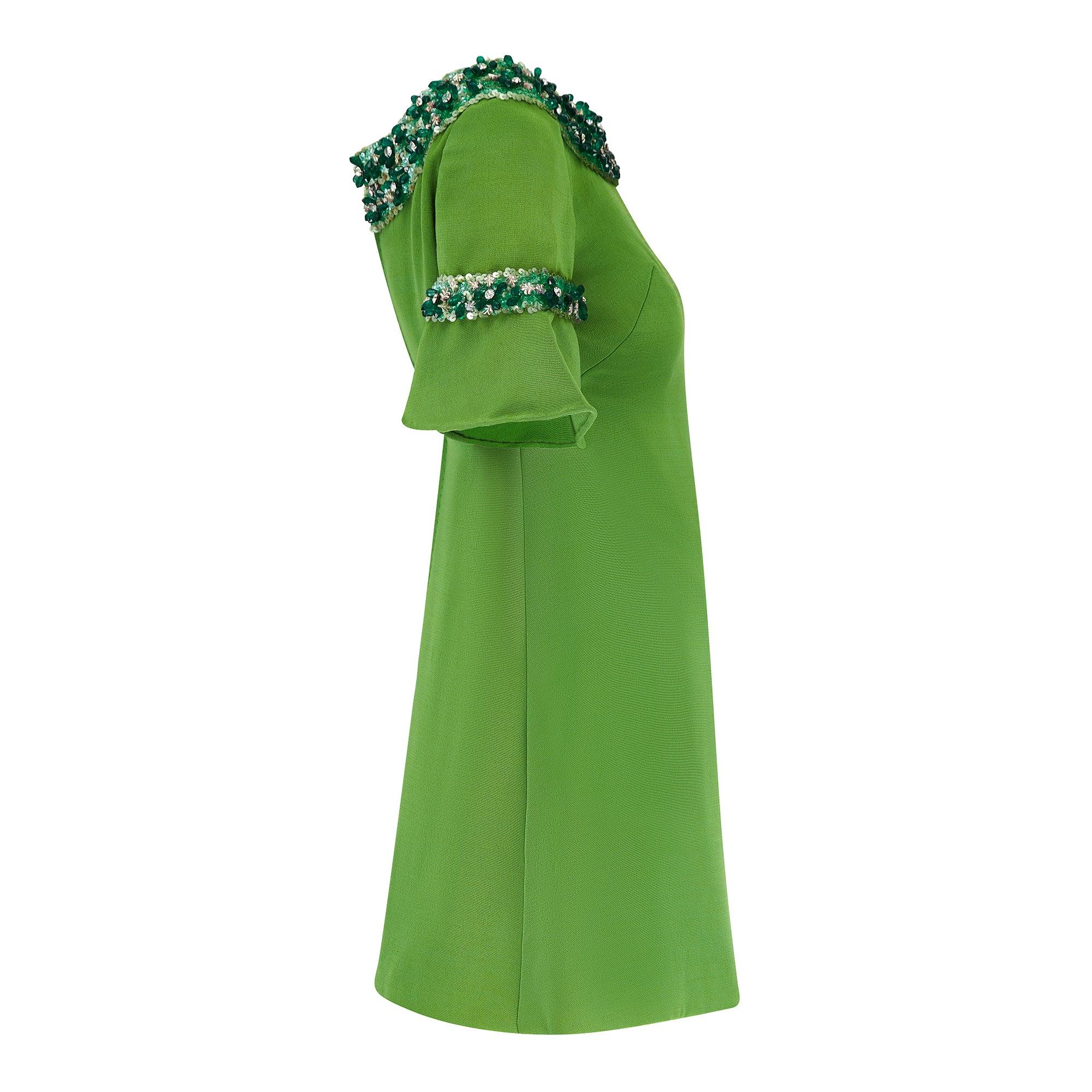 This gem-encrusted mini-dress was couture-made by Paola Sidoli during the late 1960s or early 1970s. Up close, the apple green cloth almost has the appearance of shot silk but we believe it to be a silk-wool blend and of an extremely fine quality.