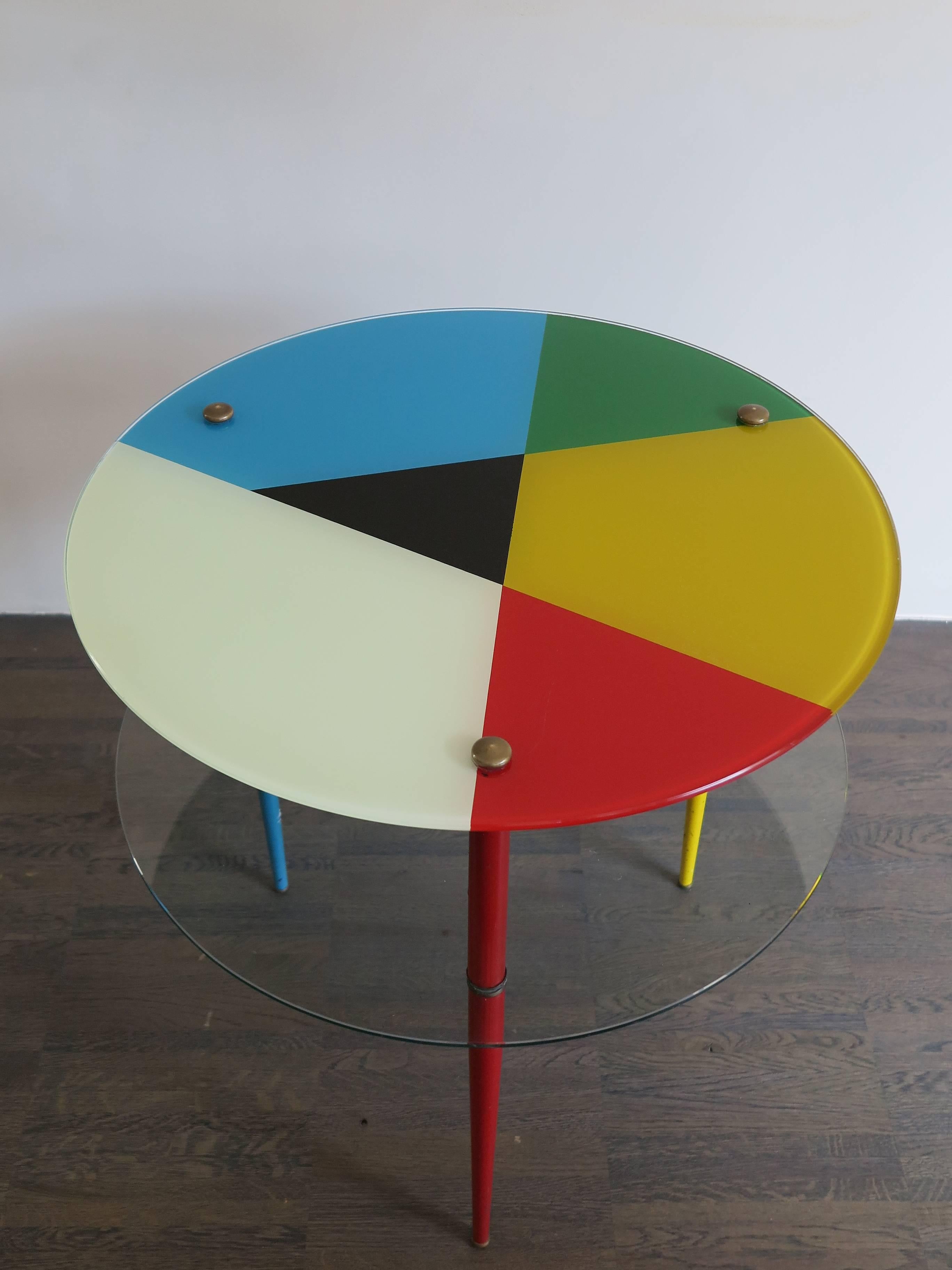 1960s Italian midcentury design coffee table designed by Paoli Edoardo for Vitrex model “Arlecchino” with painted metal legs and brass details, tempered glasses, back-painted top.
Some signs due to normal use over time.