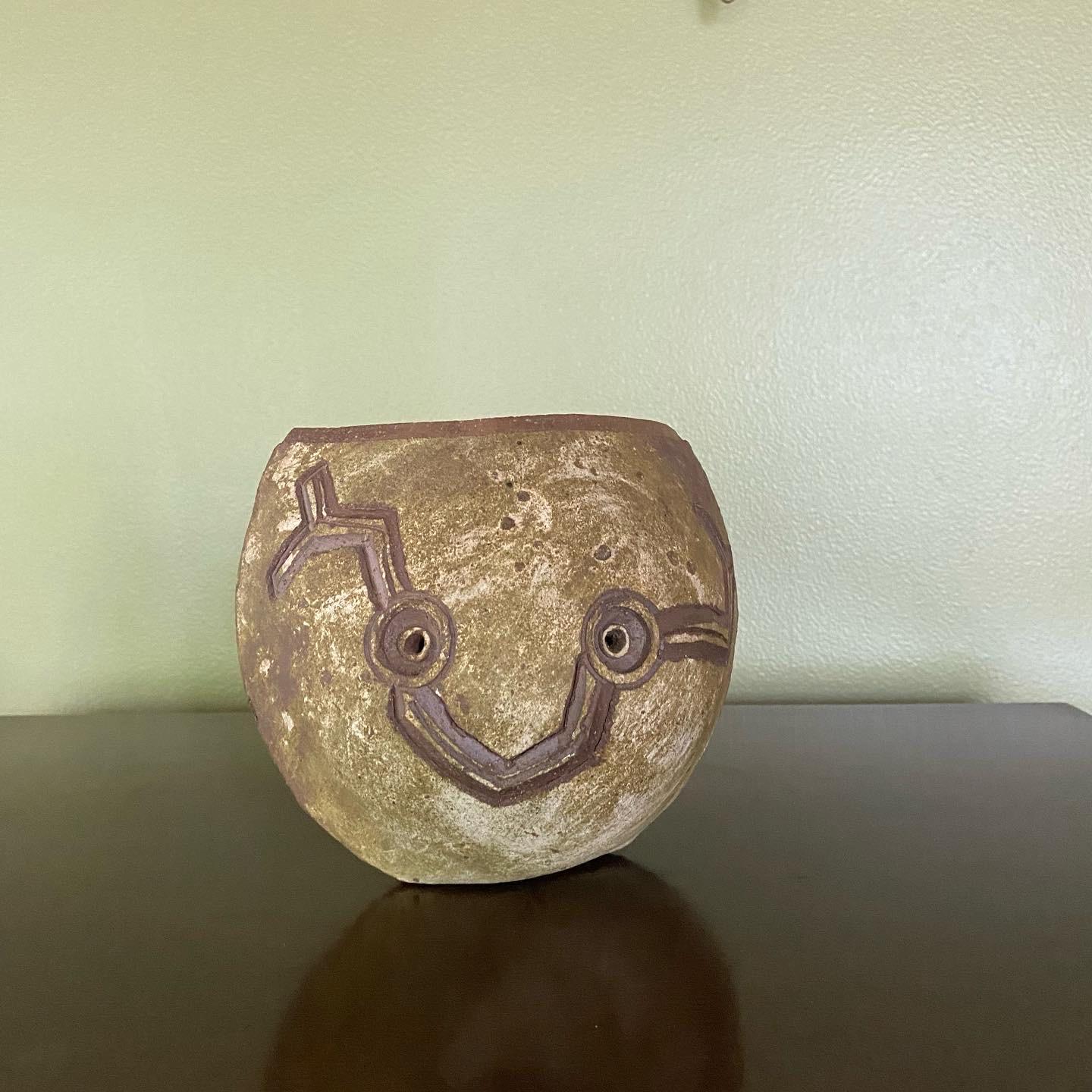 This is an exceptionally rare ceramic pottery vase handmade by Paolo Soleri at his Arcosanti studio in the 1960’s, Arizona. It’s a slab-cut form, molded from two pieces and a small bottom piece. It is hand-signed on the bottom corner.
 