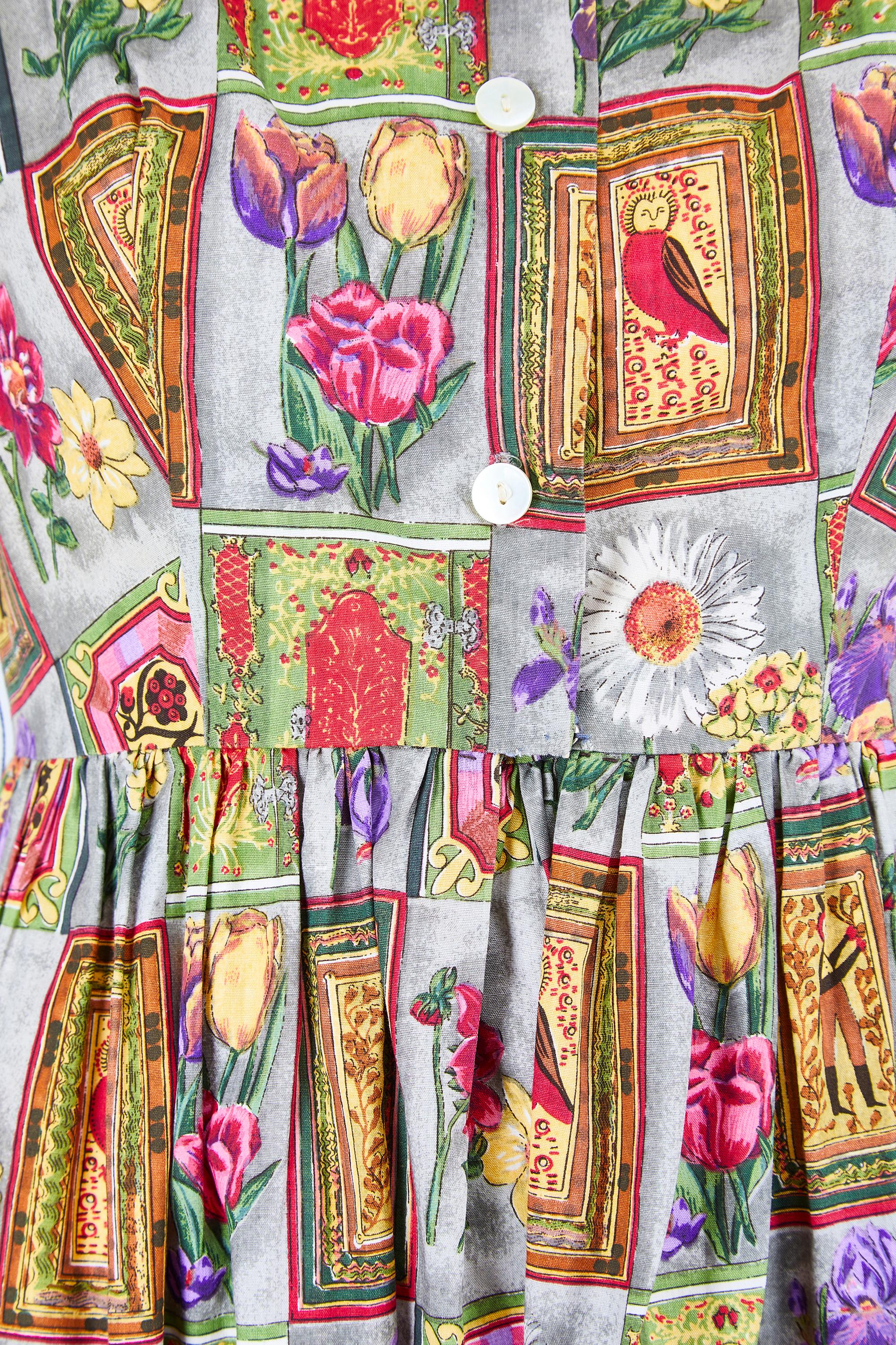 This lively cotton dress as designed in the 1960s by Parikene and probably made in France. It showcases a playful novelty print of folk art in elaborate frames and English country garden blooms. The colours are particularly vibrant for a piece of