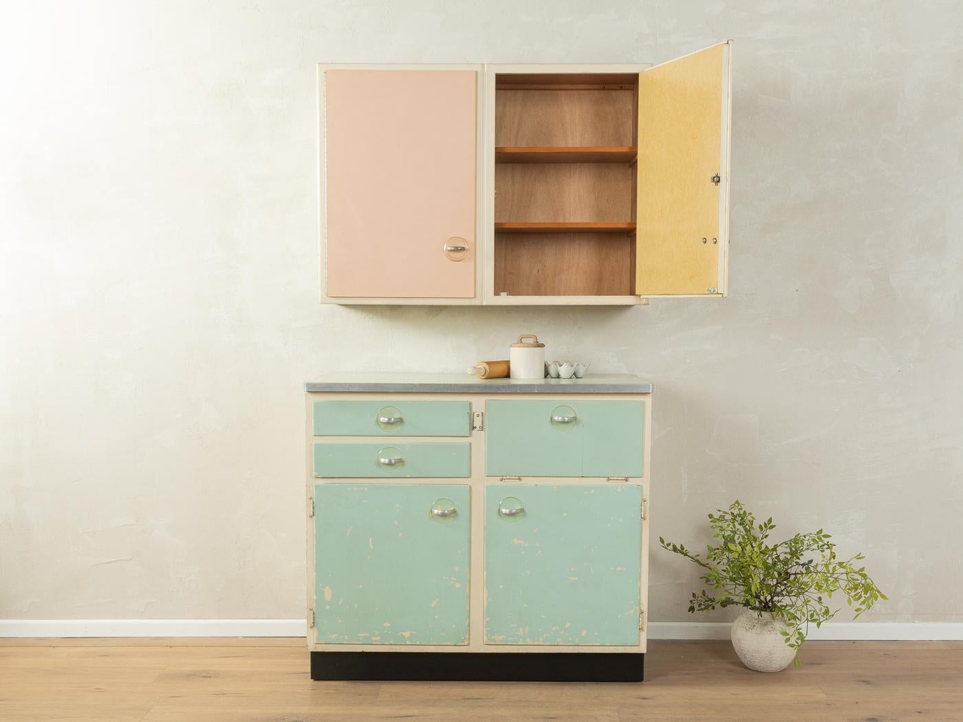 Unico mobile da cucina a due pezzi degli anni '50 dal design tipico dell'epoca. Corpo di alta qualità con quattro ante dell'armadio, un'anta a ribalta, due cassetti, tre ripiani e una base nera a contrasto. L'interno del mobile da cucina è stato