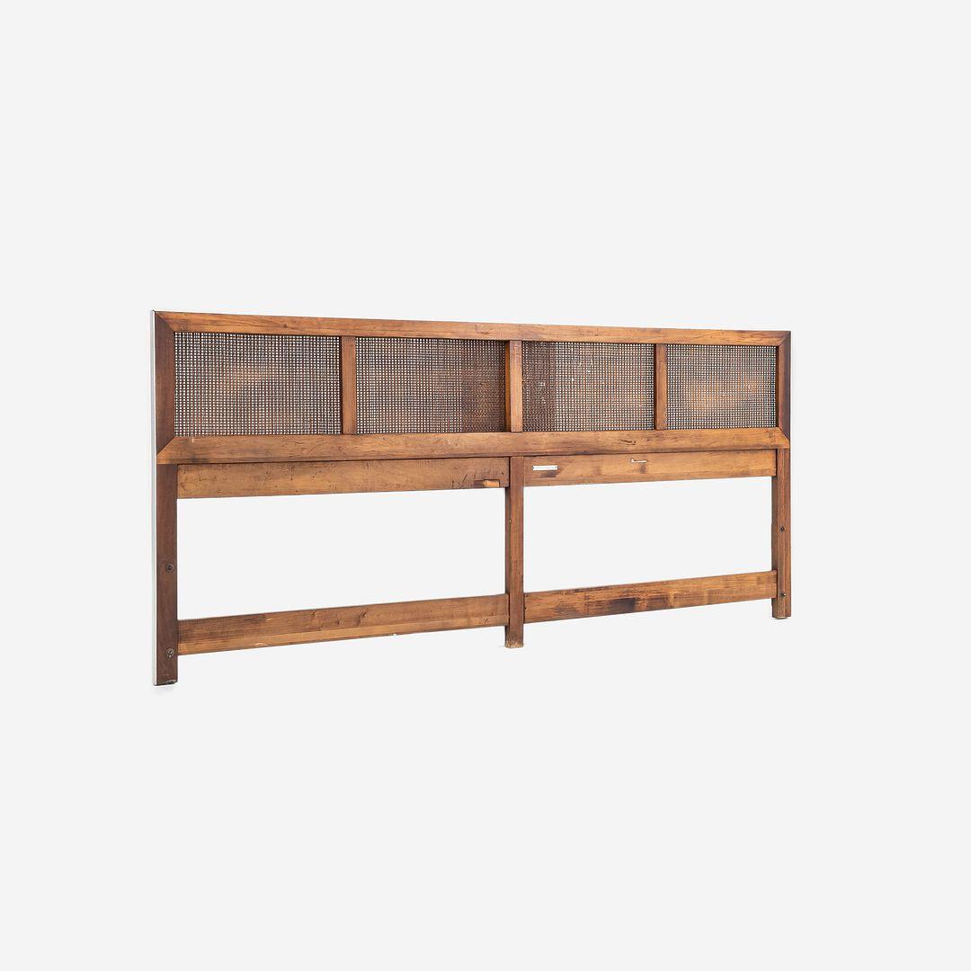 This is a King-Sized Headboard, Model #7703, designed by Paul McCobb and produced by Calvin Furniture in the 1960s. It features a frame of American walnut, outlined by a brushed steel strip, and has inset panels with caning. 
 The headboard measures