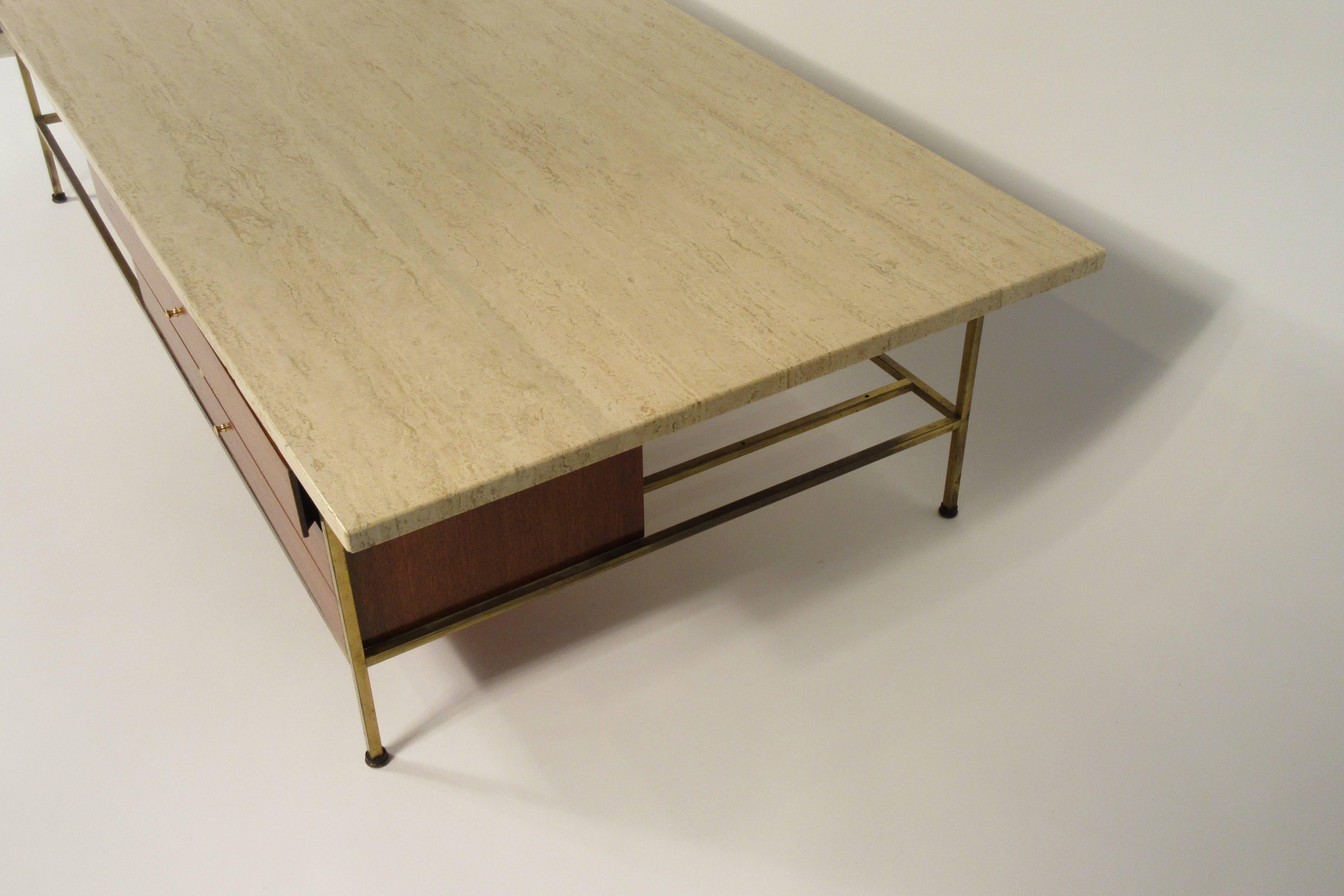 1960s Paul McCobb walnut coffee table with travertine top. Label in drawer.