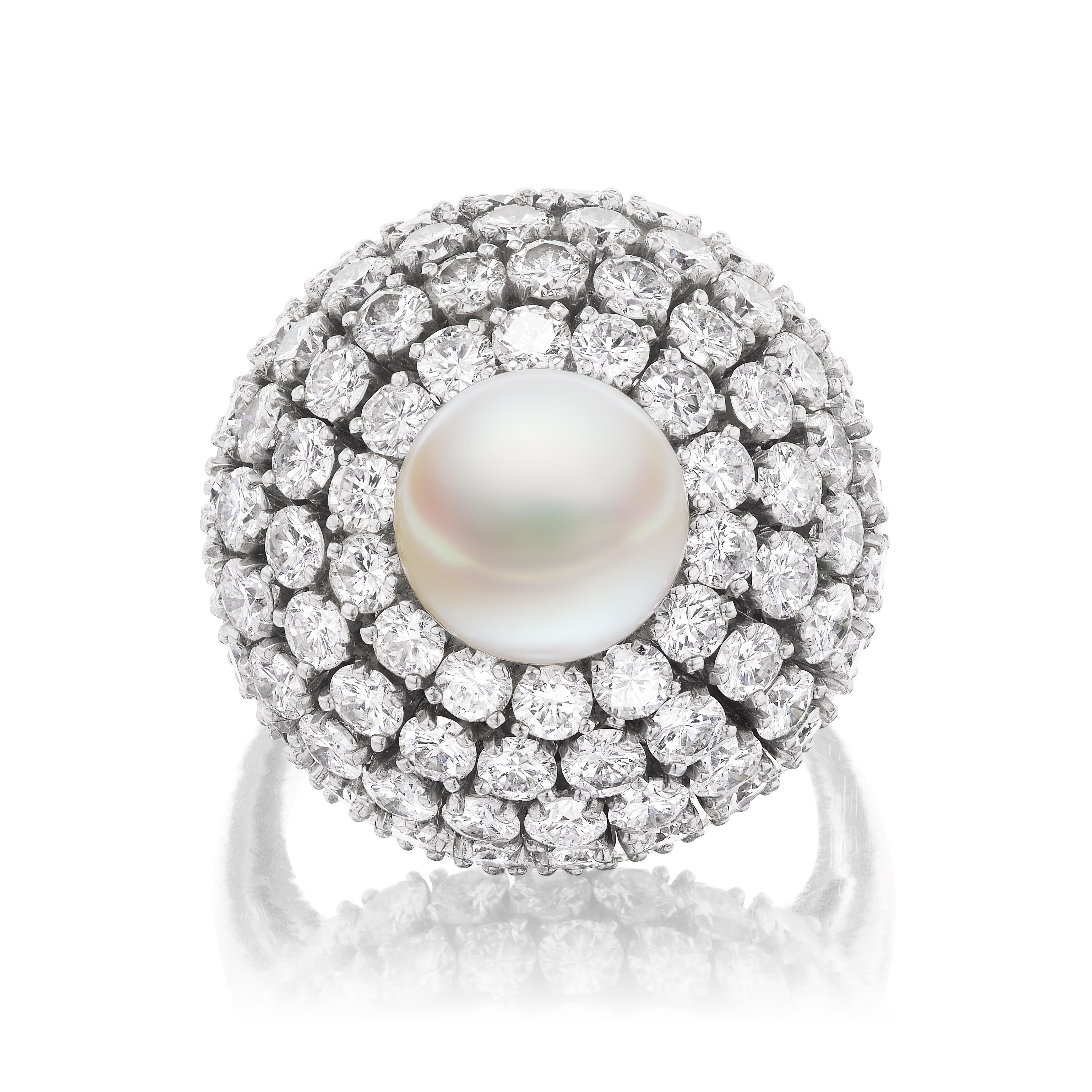 A beautiful assemblage of 108 round brilliant diamonds weighing approximately 6 carats accenting a lovely and impressive 9.5mm pearl perched atop this mid-century fashion bombe design. A fantastic and timeless cocktail ring to enhance any collection.