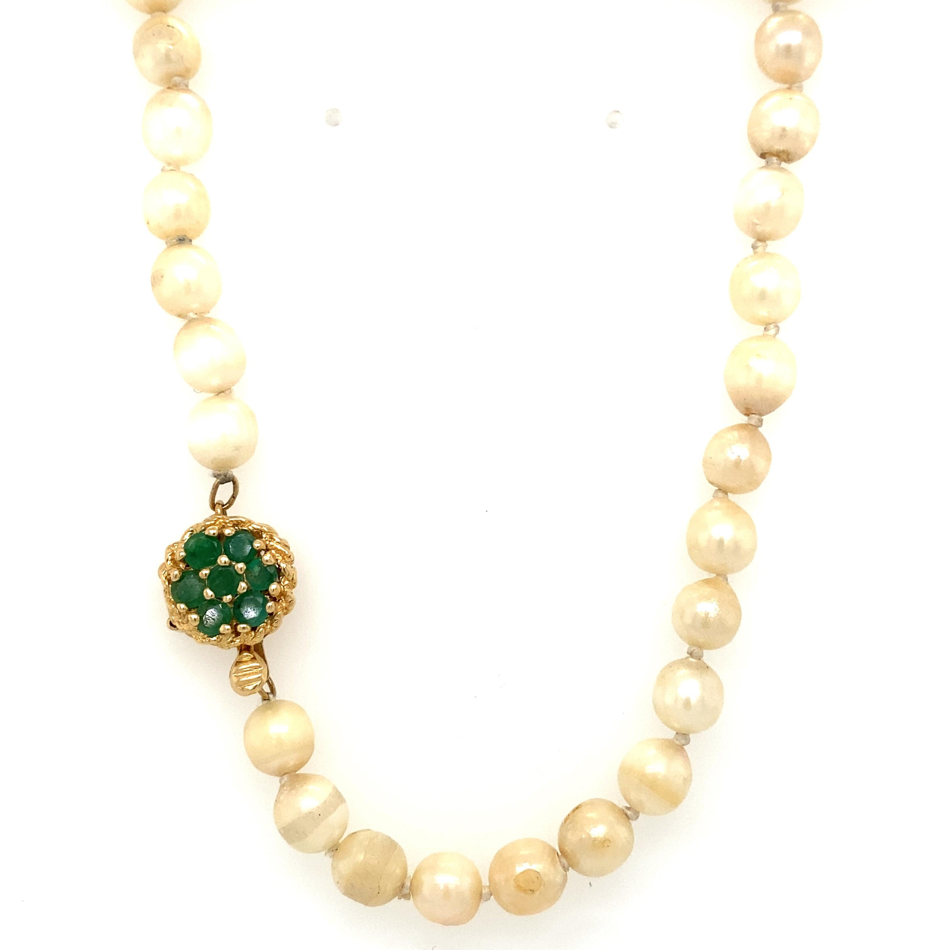 Item Details: This choker-length pearl strand has a clasp with vibrant green emeralds. It is a beautiful vintage piece that makes an excellent gift.

Circa: 1960s
Metal Type: 14 Karat Yellow gold
Weight: 19.7 grams
Size: 15.5