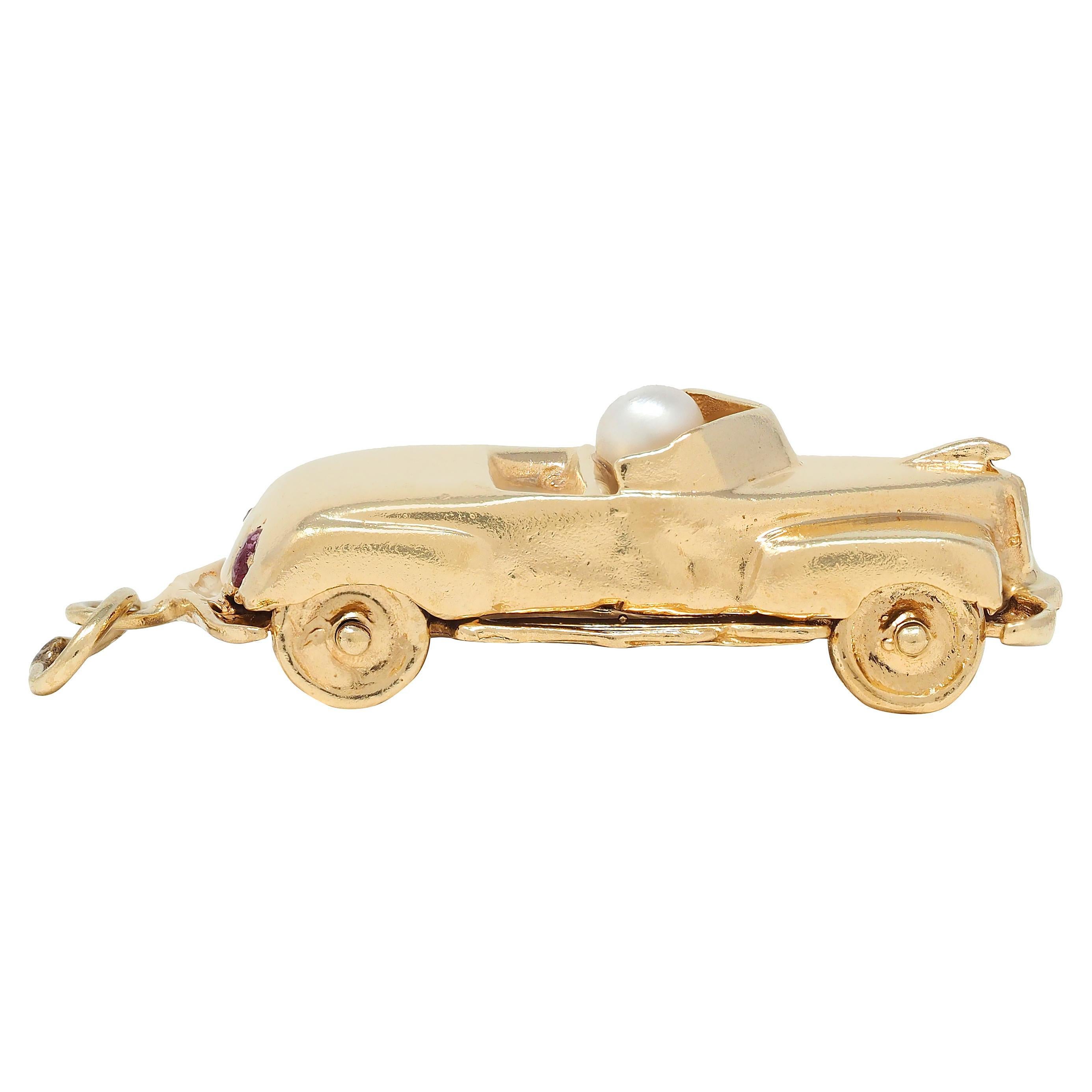 Designed as a dimensional vintage-style car with open cab and grooved details
Featuring four rolling wheels that spin on matching axis
Accented by a 3.5 mm round pearl as a passenger
White in body color with moderate iridescence
Headlights are flush
