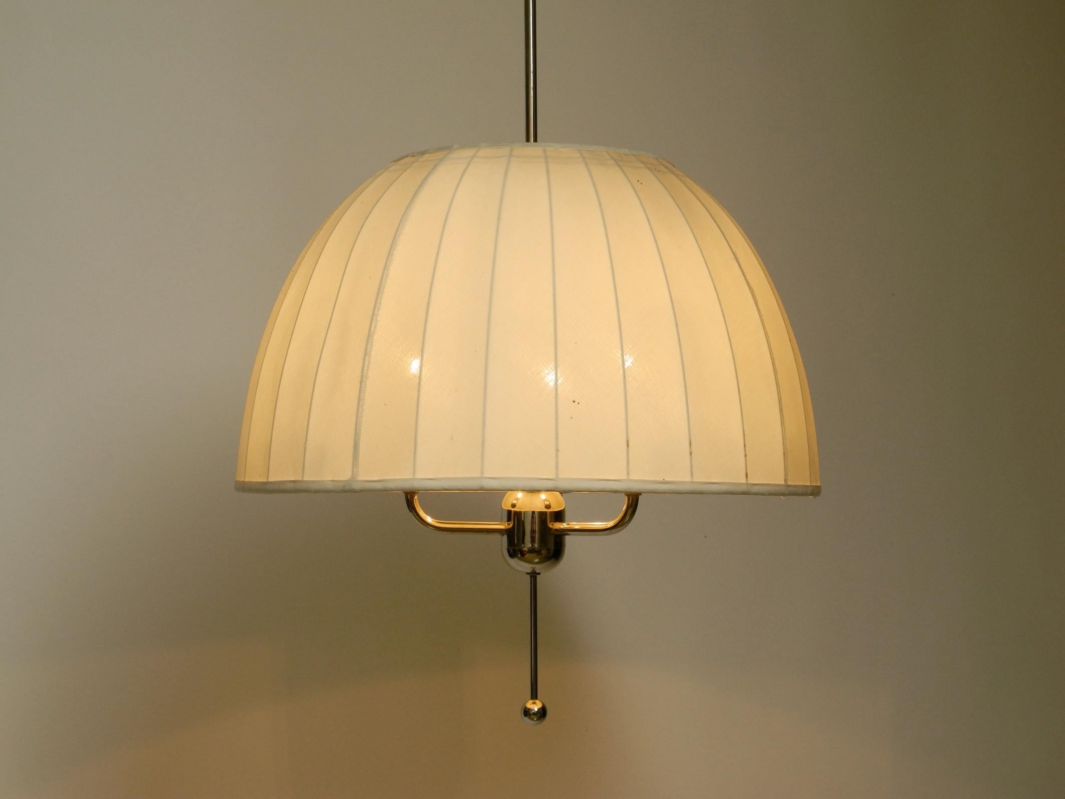 Beautiful original 1960s pendant light “Carolin” model T549.
Designed by Hans-Agne Jakobsson for Markaryd. Made in Sweden.
Complete frame and canopy are made of shiny nickel-plated brass.
The height of the lampshade is adjustable.
The lamp with the