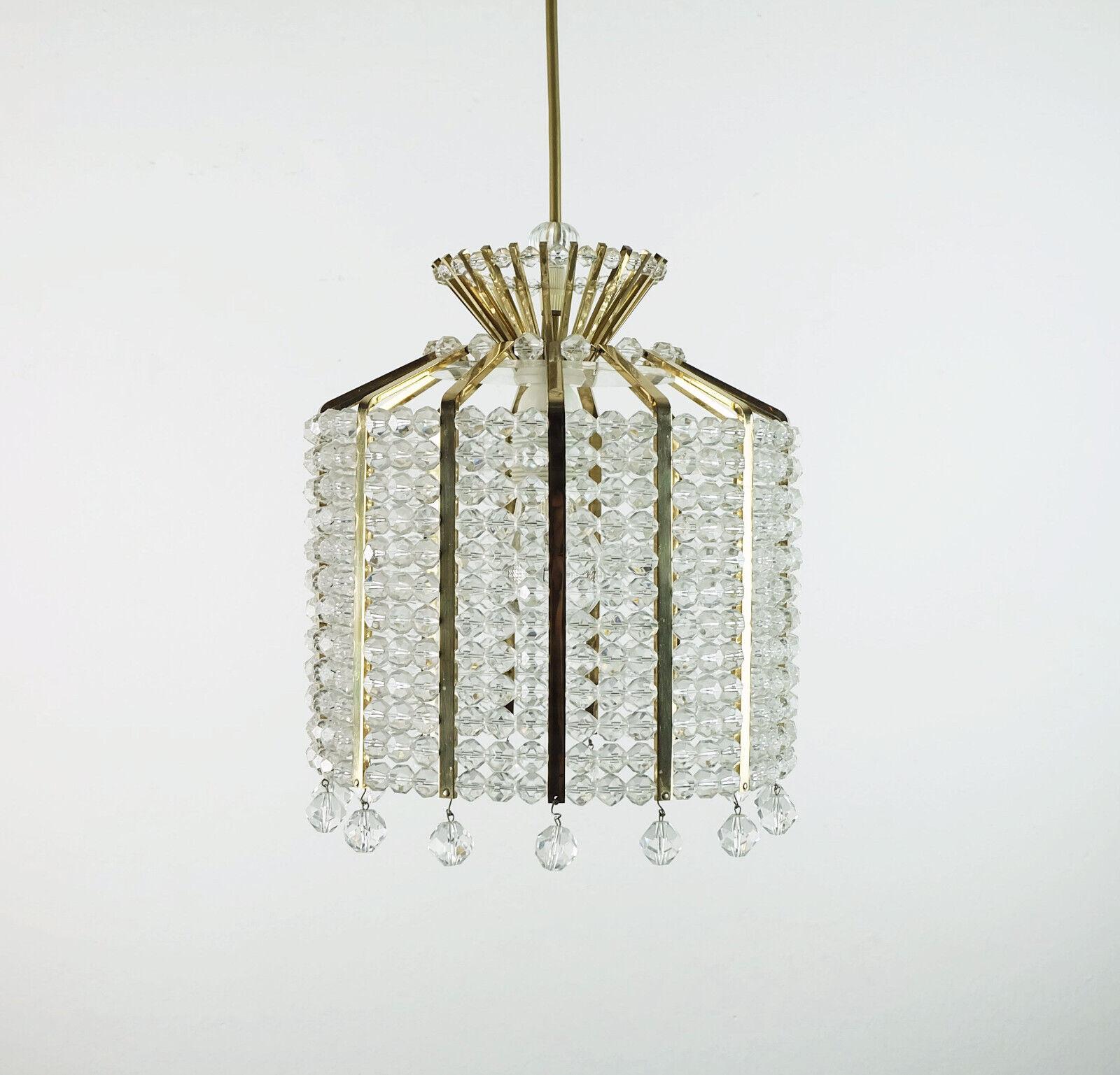 Fantastic and glamorous vintage pendant light, unbranded, but most likely manufactured by Palwa (Palme & Walter) in the 1970s. The shade is made of faceted acrylic pearls, which are lined up between brass rods. Gold colored electric wire, brass