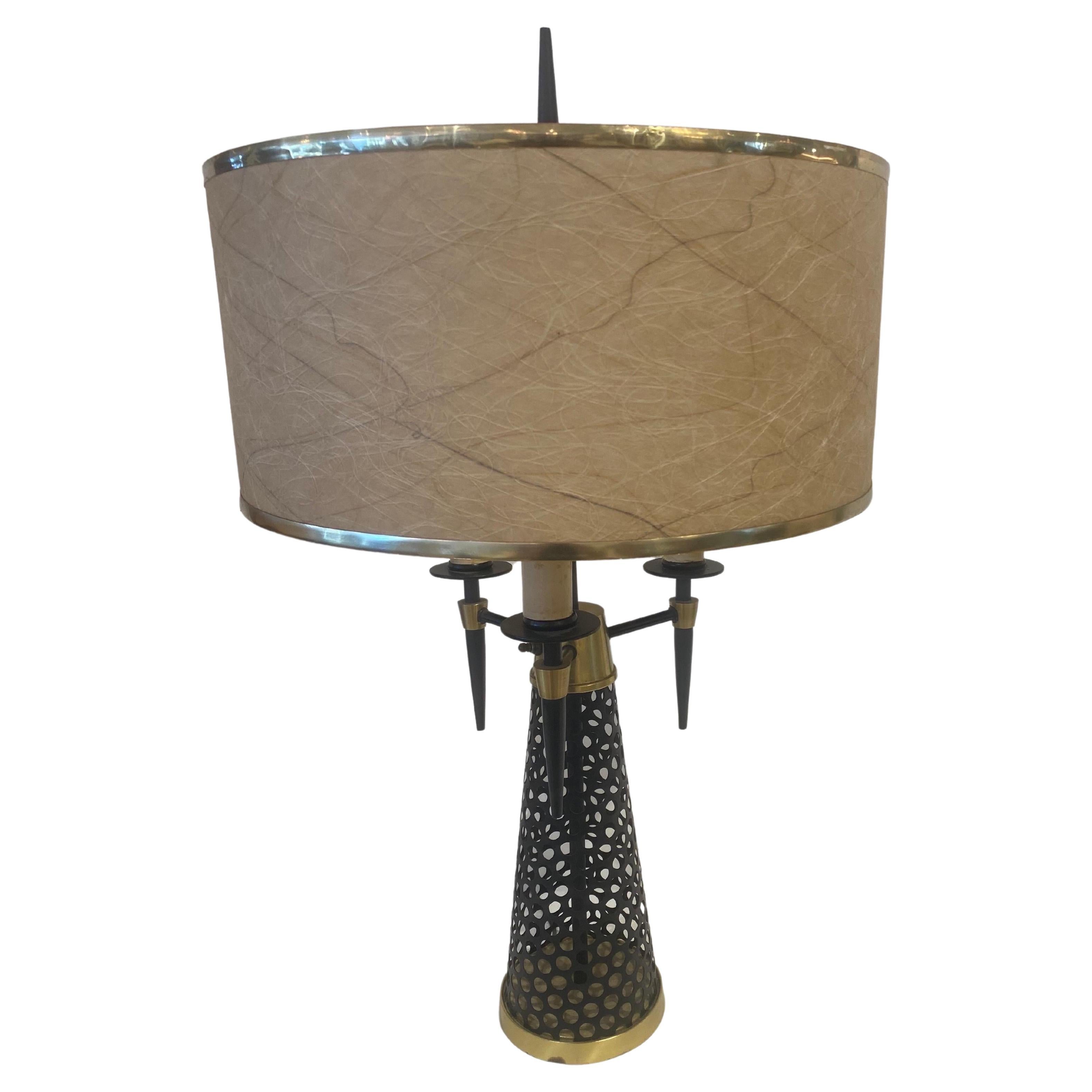 This wonderful black perforated metal cone base with brass base and accents throughout, has 3 Edison standard bulbs and finial. Original brass trimmed shade shown is included.  THIS ITEM IS LOCATED AND WILL SHIP FROM OUR MIAMI, FLORIDA SHOWROOM.