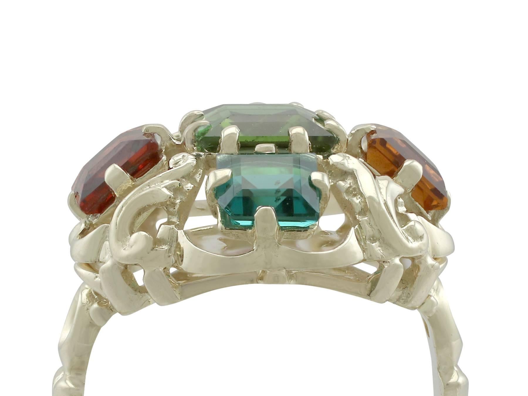 A 1.30 carat peridot, 0.74 carat citrine, 0.88 carat garnet, 0.62 carat amethyst, 0.66 carat tourmaline and 14 karat yellow gold cocktail ring; part of our diverse vintage jewelry collections.

This fine and impressive multi gemstone ring has been