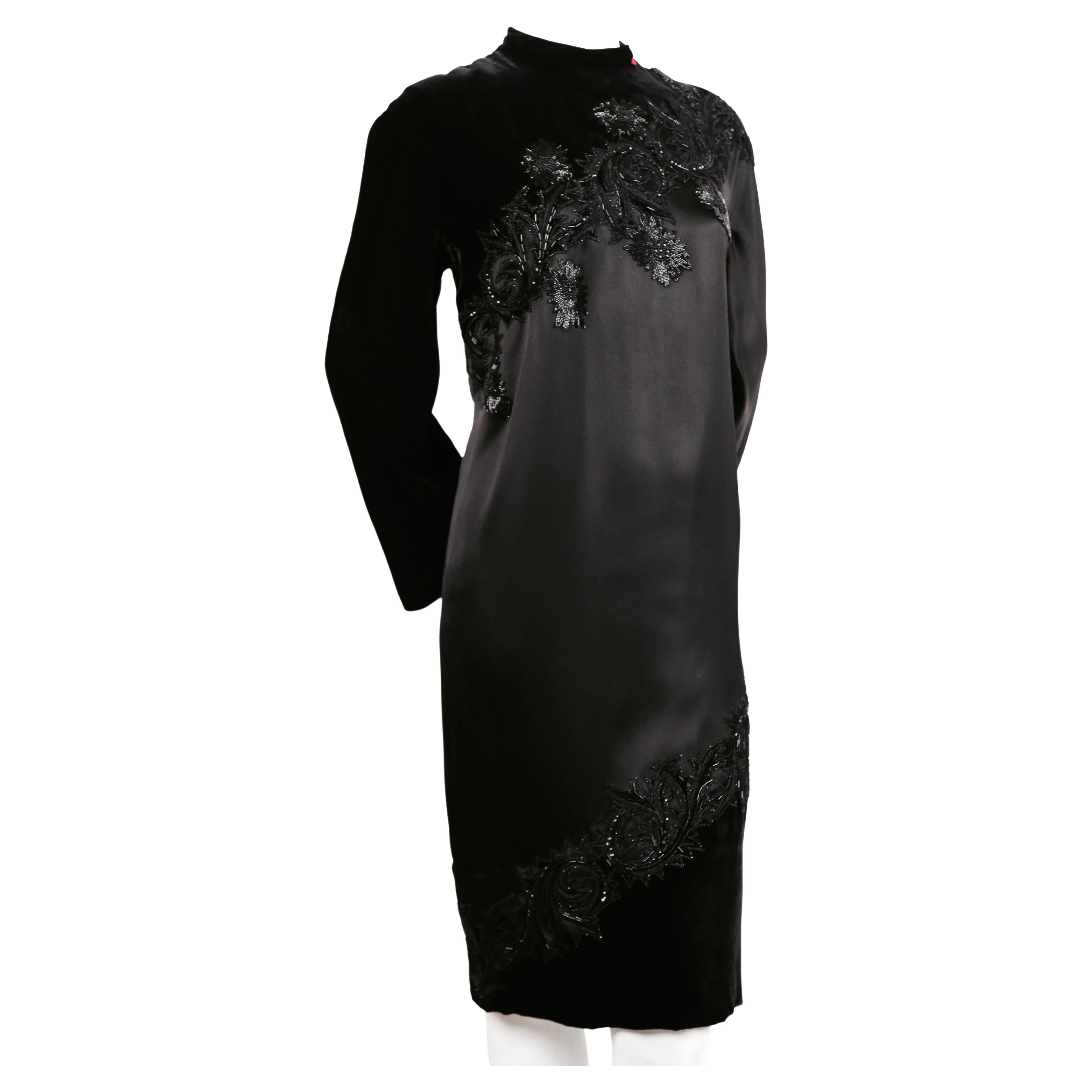 Very rare jet black silk satin and velvet haute couture dress with unique spiral design and elaborate beading designed by Pierre Balmain dating to the 1960's. Dress has a red bow at neckline which indicates that it was made for a recipient of the