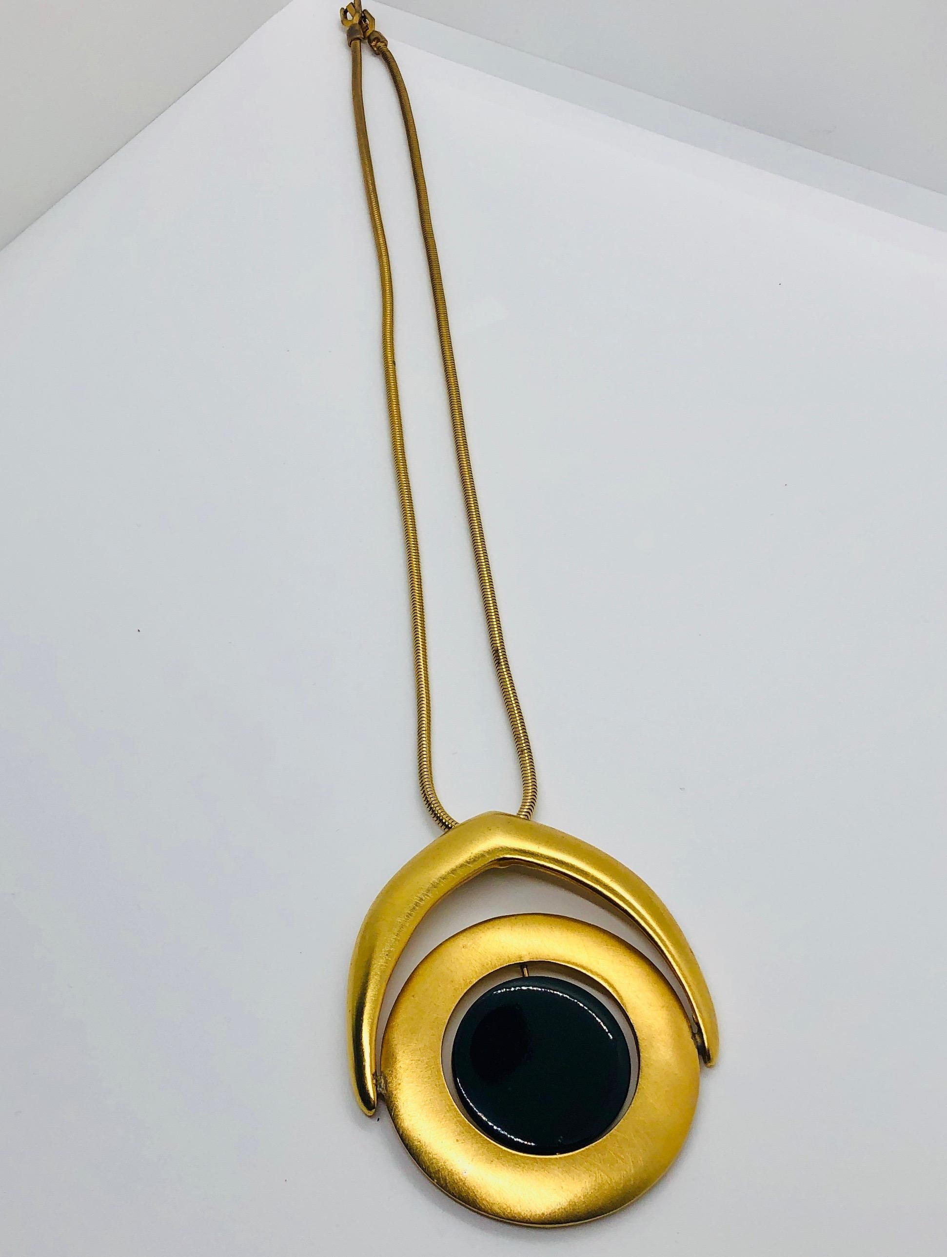 Offered is a signed 1960's Pierre Carding gold plated krementz chain with Egyptian style black to white enameled rotating pendant necklace.
Make:  Pierre Cardin (stamped)
Place of Manufacture:  France
Color:  Gold, black and white
Materials:  Gold