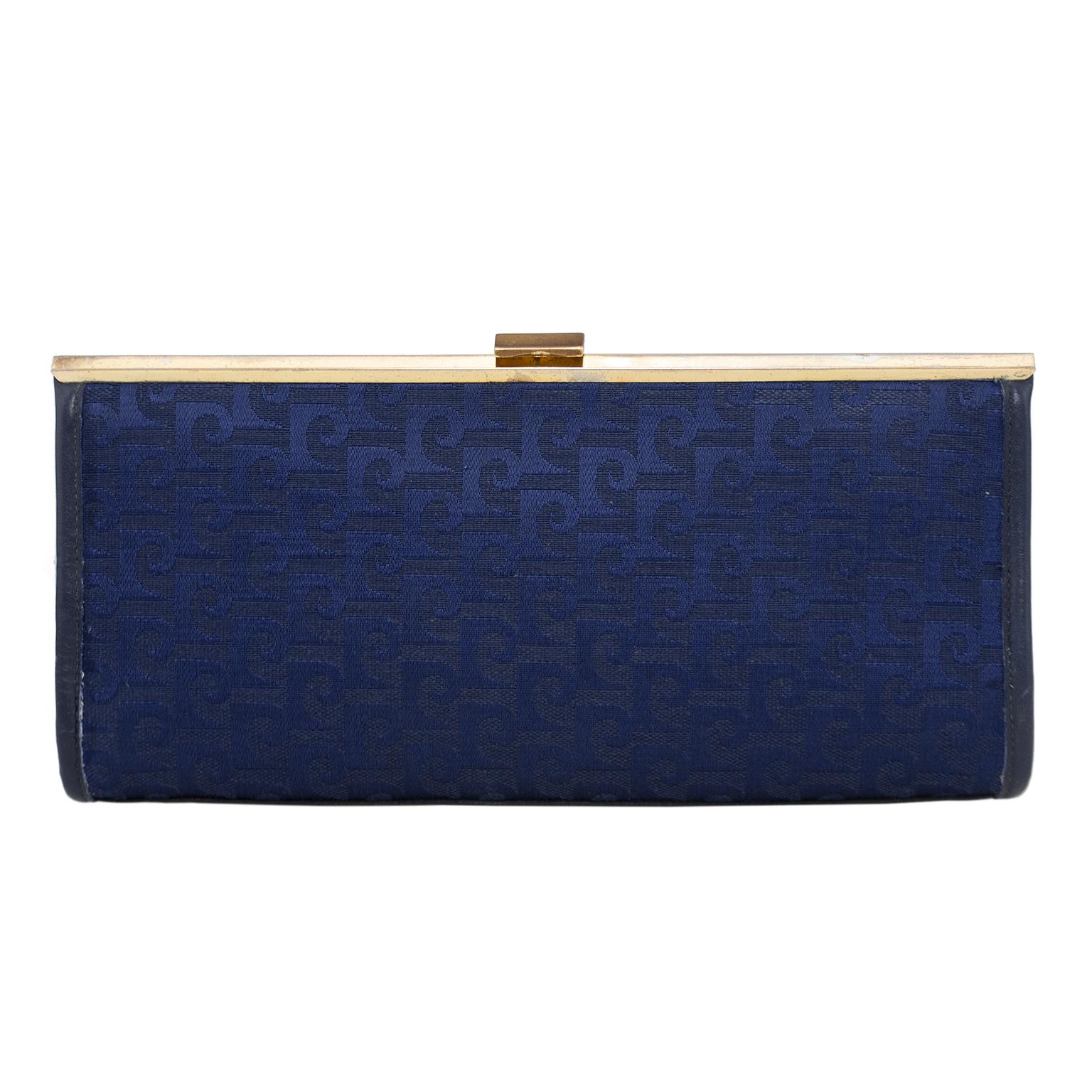 Pierre Cardin clutch from the 1960s. Frame style with gold tone metal frame and clasp. Navy blue jacquard with all over Pierre Cardin logos. Navy blue lining and single horizontal zip slit pocket. A great and lightweight clutch for a night out. Very
