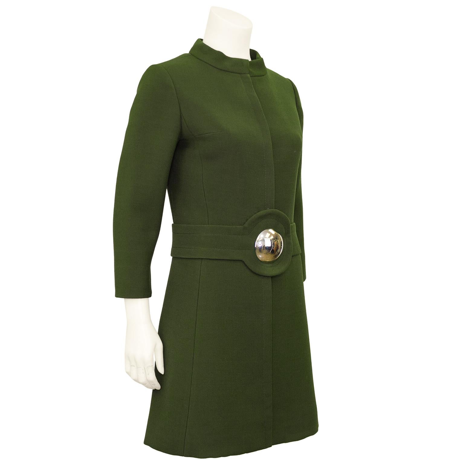 1960s mod Pierre Cardin is the chicest of the chic, and this olive green wool coat dress is no exception. Shift shape with a mandarin collar, bracelet length sleeves and a hidden button placket down the centre seam. Large spherical silver metal
