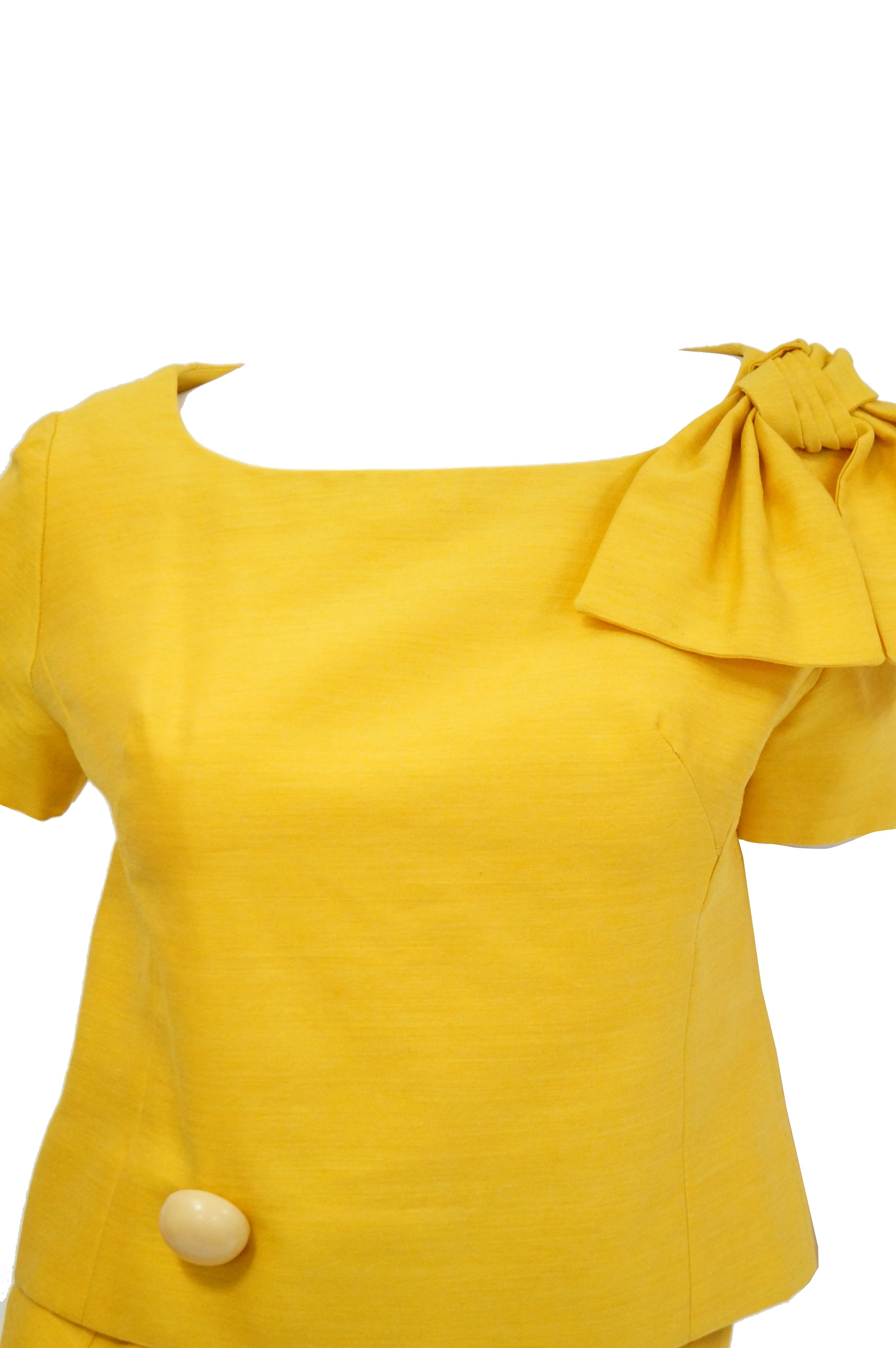 Gorgeous brilliant mod shift ensemble by Pierre Cardin! The ensemble is composed of a bottom dress layer with wool skirt with connected slip camisole, and a separate blouse. The skirt is knee - length with an A - line silhouette, the blouse is hip 