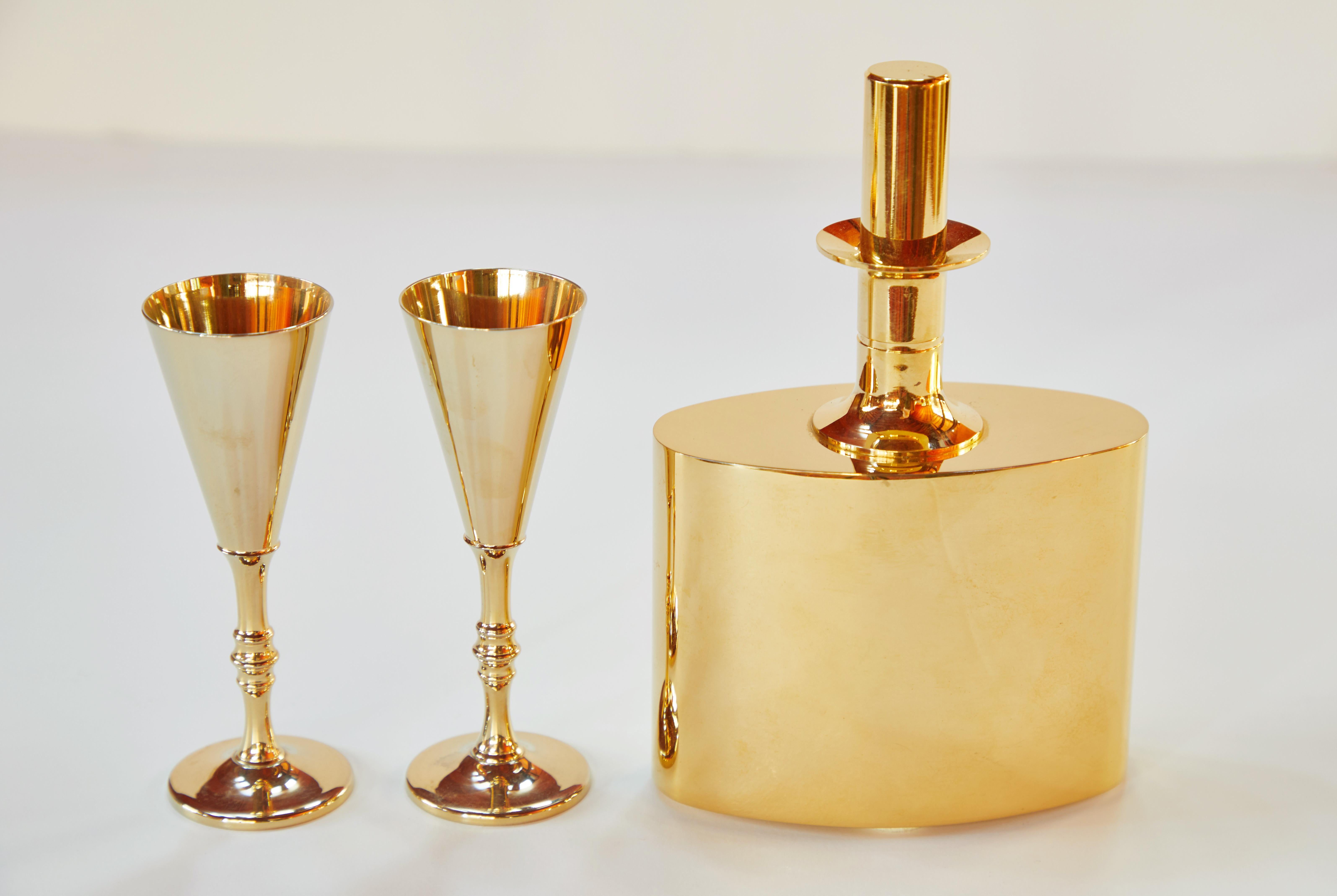 1960s Pierre Forsell Flask and Glasses for Skultuna. Executed in solid brass plated with 23-carat gold. Manufacturer's stamp on each piece. 

Price is for the set.

Flask measures 7 inches high by 5 inches wide by 2.25 inches deep
Glasses