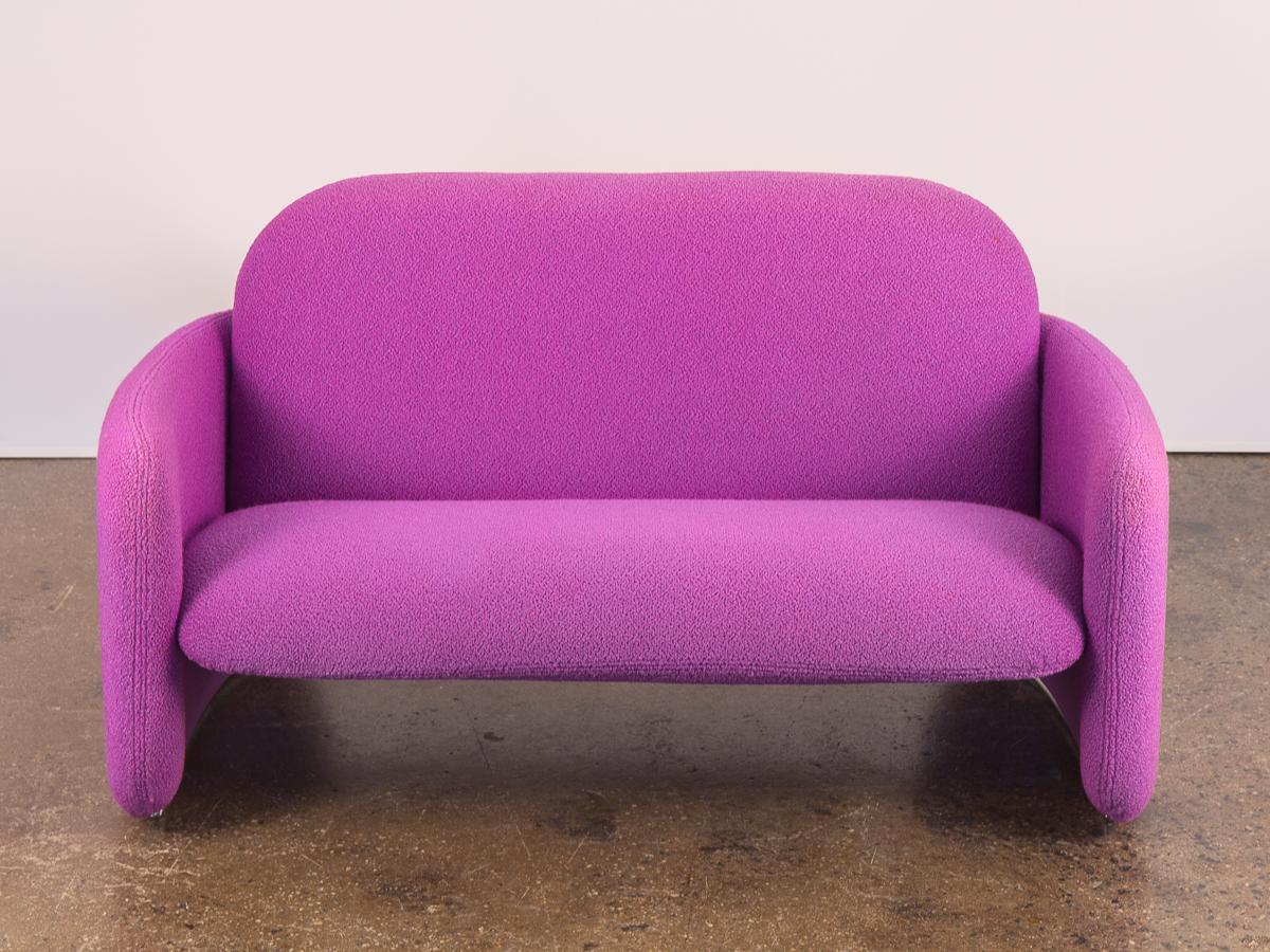 1960s purple magenta loveseat in the manner of Pierre Paulin. A Space Age, pop-era form, bold with color and upholstered in a textural boucle. This shapely two-seater floats on curving, rounded planes and is striking especially from the back. Plush