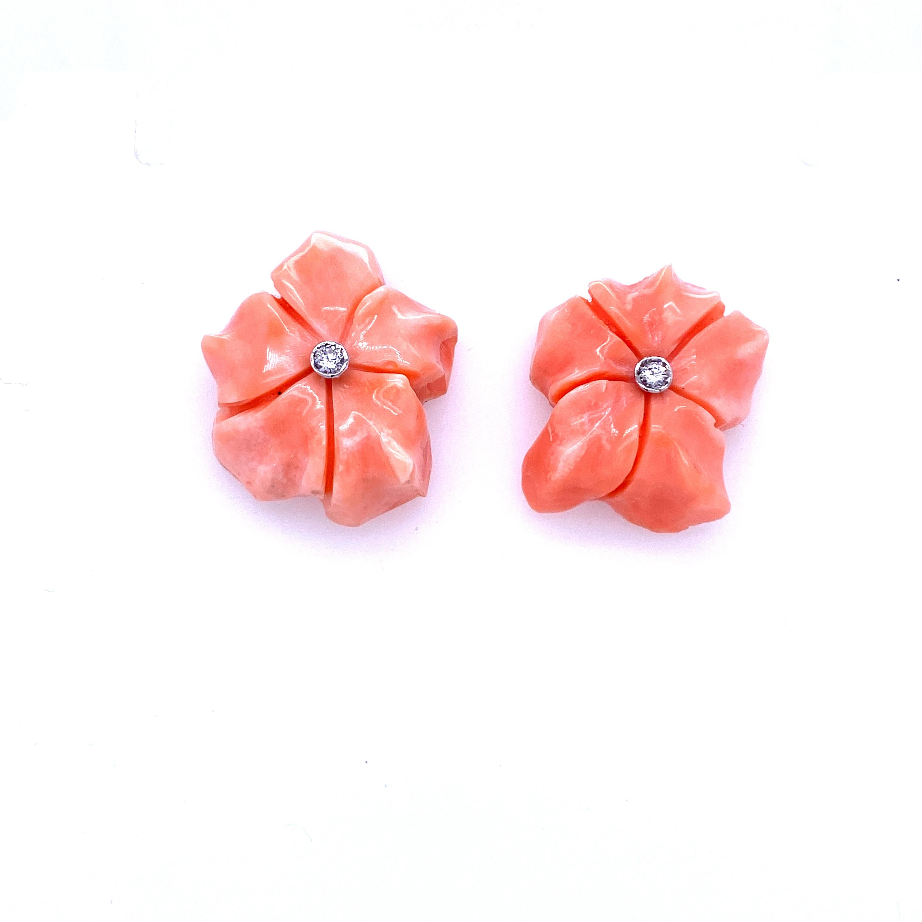 An unusual pair of vintage diamond flower design earrings set in 18k Gold and hand-carved Coral.
The pink Coral is studded with round brilliant diamond .10 carats, graded color G clarity Vvs1. 
Every coral has a different shape, this make them