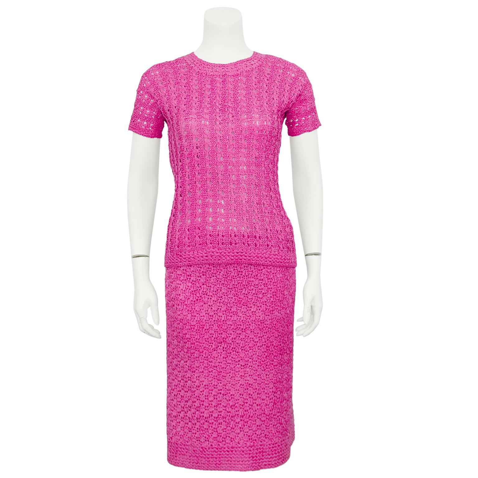 1960s bright pink crochet 3 piece suit by Lola Lemans. The set consists of a classic shaped blazer with a notched collar and three buttons, a crew neck short sleeve t-shirt and a classic high waisted straight knee length skirt. Very charming as a
