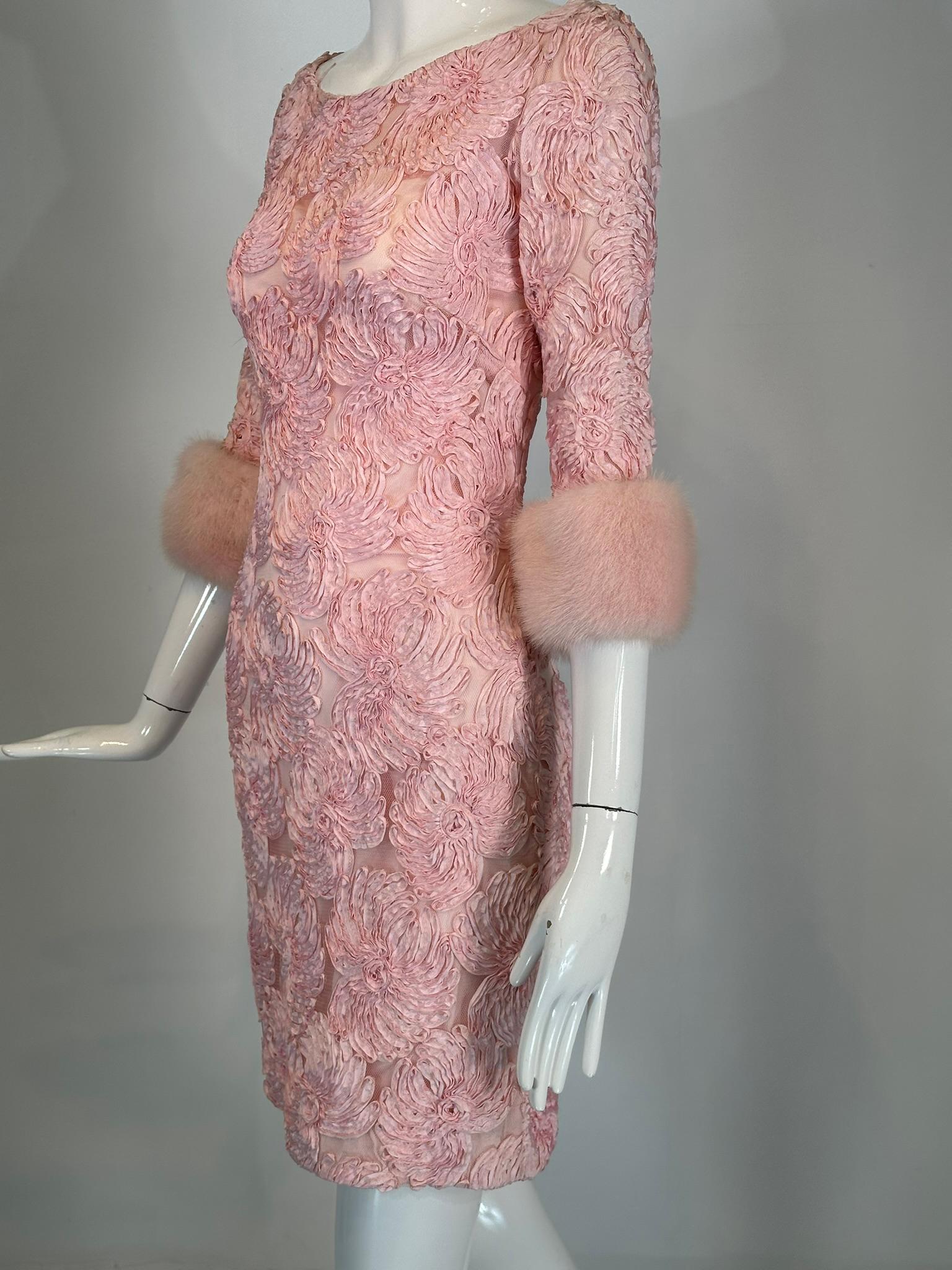 1960s vintage pink ribbon floral applique on net cocktail dress with pink mink cuffs. Gorgeous dress for any special occasion. Scoop neck dress has 3/4 length sleeves with wide pink mink cuffs. The sheath style dress is fitted through the bust,