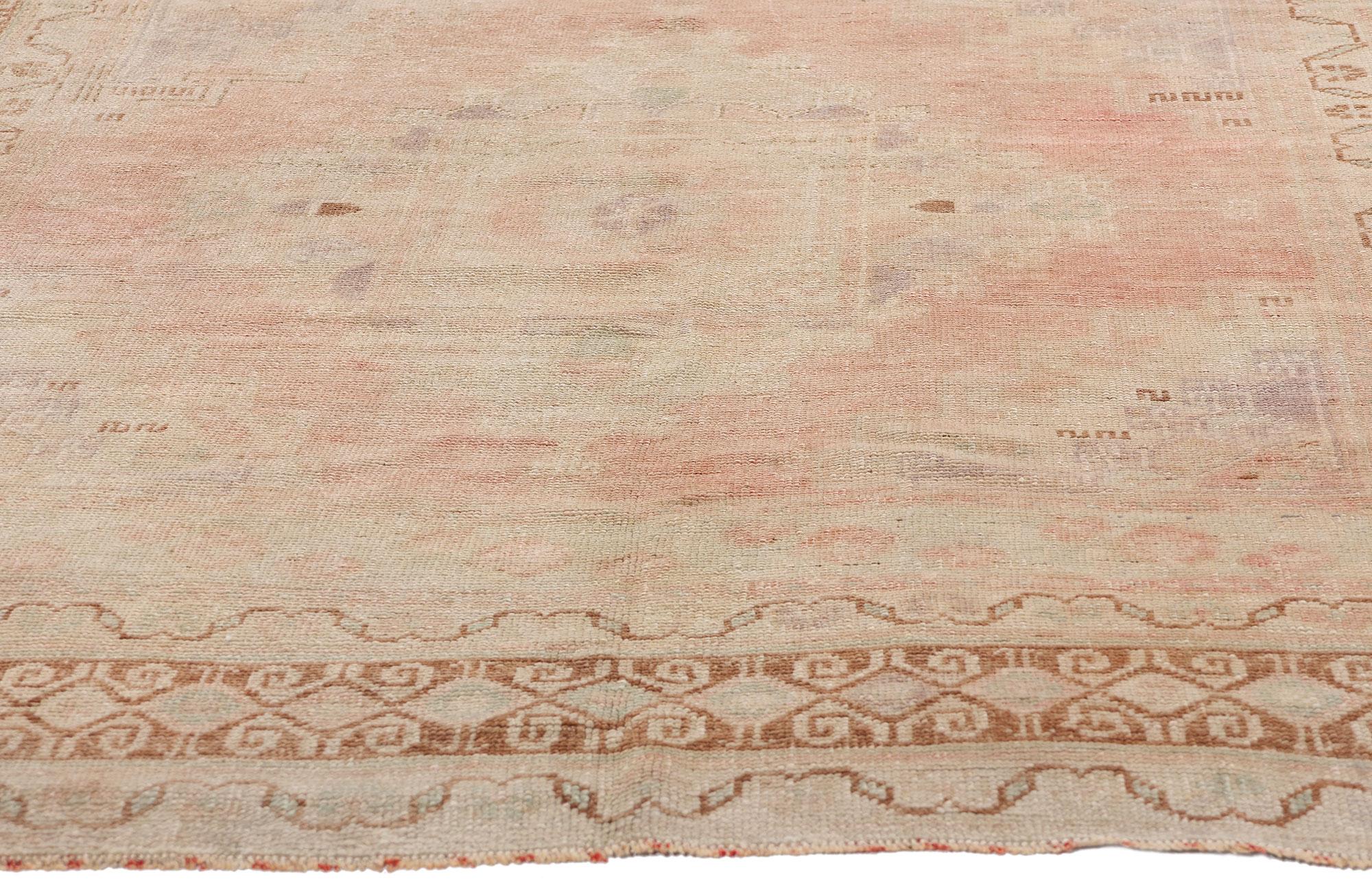 53560 Vintage Turkish Oushak Rug, 05'03 x 09'04. Bathed in the soft glow of time, this hand-knotted wool vintage Turkish Oushak rug exudes an ethereal beauty, its antique-washed hues whispering stories of Anatolian heritage. The delicate pink field,