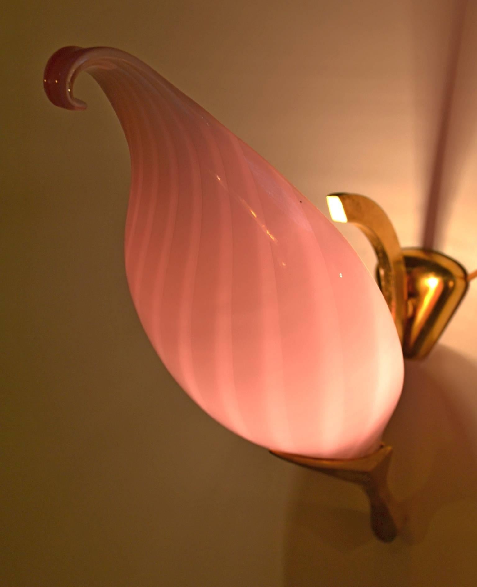 A pair of drop shaped wall sconces with striped pink glass set in gold wall brackets by Venini.