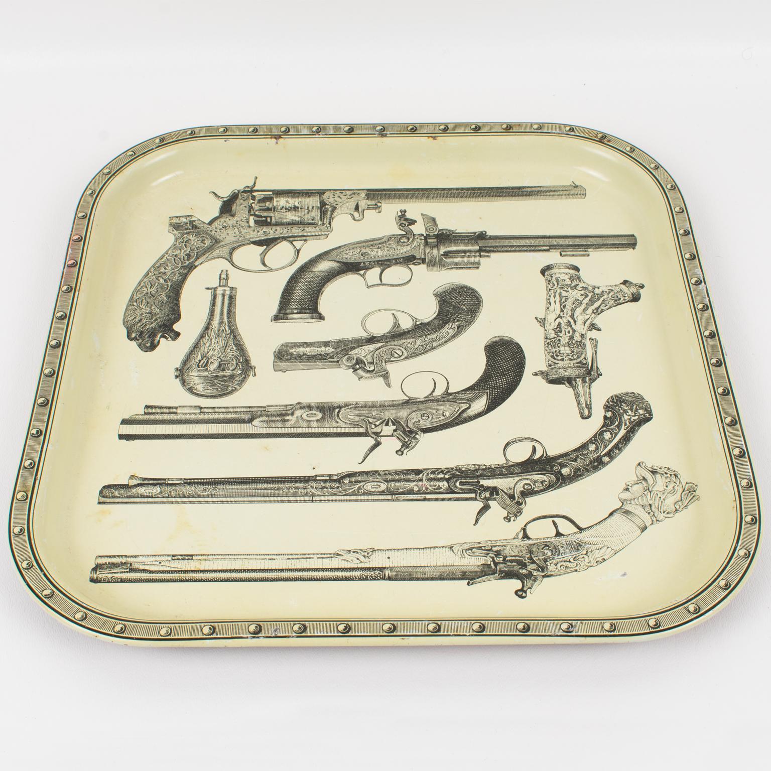 Studio Fornasetti pistol tray from the 1960s, design attributed to Piero Fornasetti, Italy. Very decorative square enameled metal tray featuring a cool and quirky print of antique pistols, guns, and gunpowder pouches. The underside has a printed