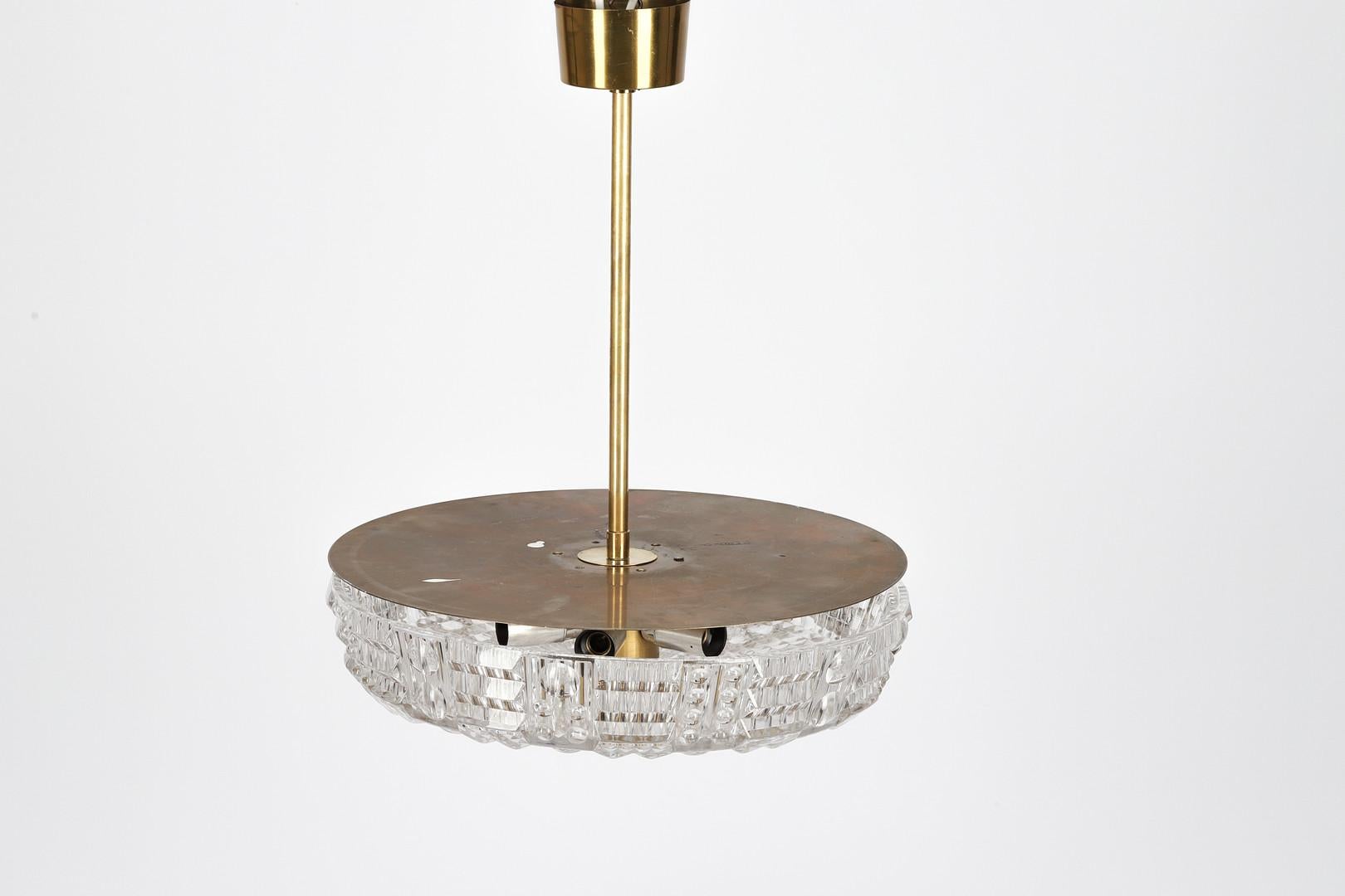 A Swedish Orrefors ceiling fixture made by Carl Fagerlund with textured molded glass dish having canted sides and round plate. Each fixture has new wiring with 6 UL certified sockets.