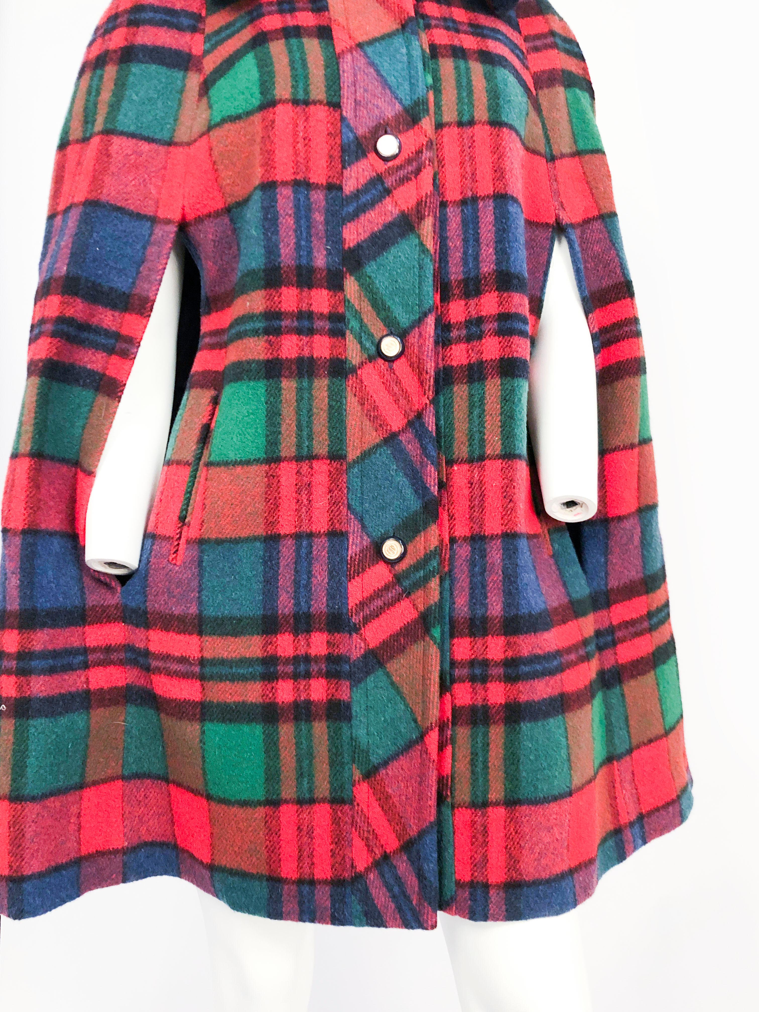 1960s Plaid Wool Cape with Navy Faux Fur Collar, decorated buttons, arm slits, pockets, and a full satin lining.