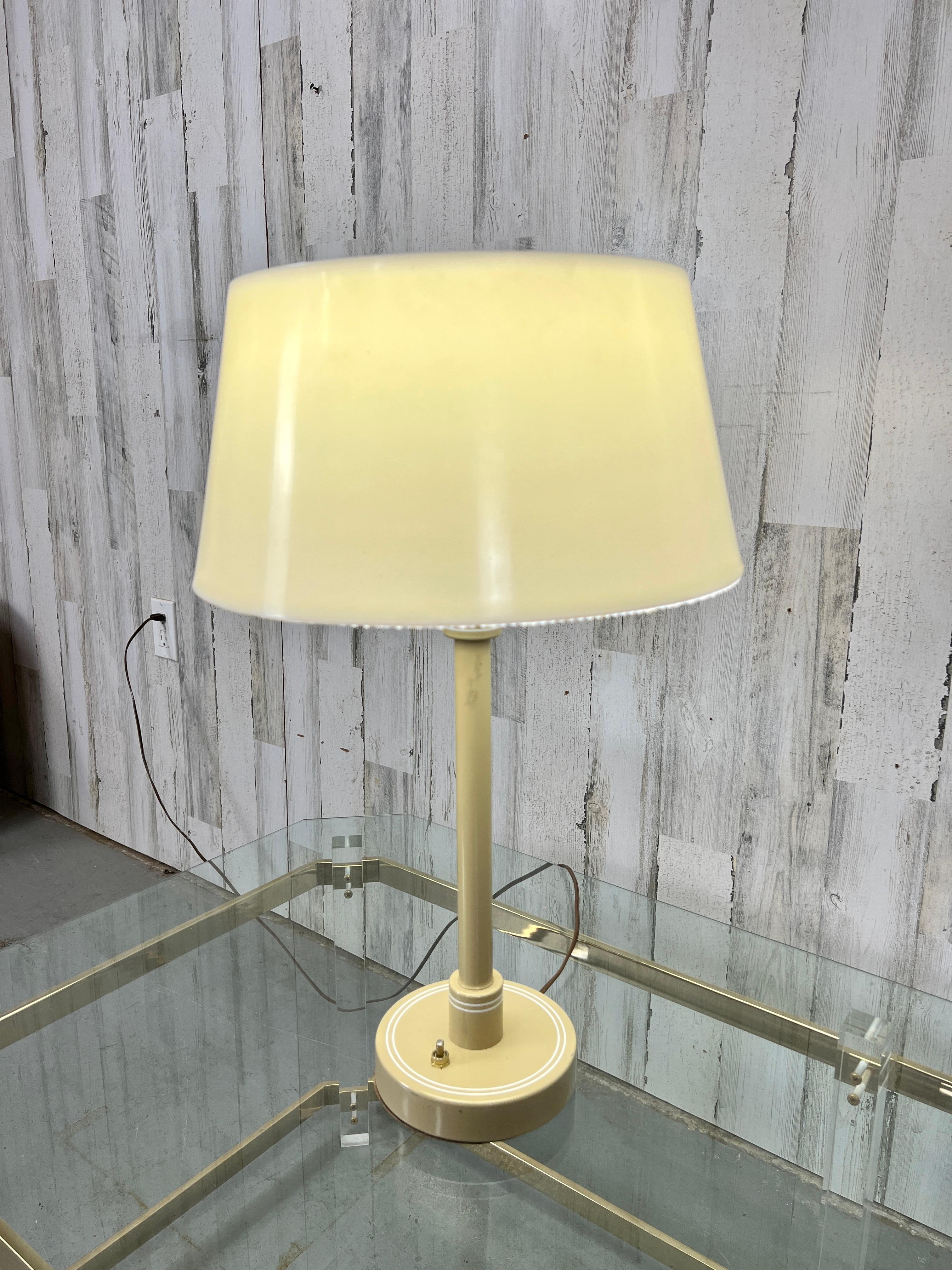 Metal painted base with plastic drum shade, also plastic diffuser at the bottom and removable metal diffuser at the top. In the style of Gerald Thurstan.