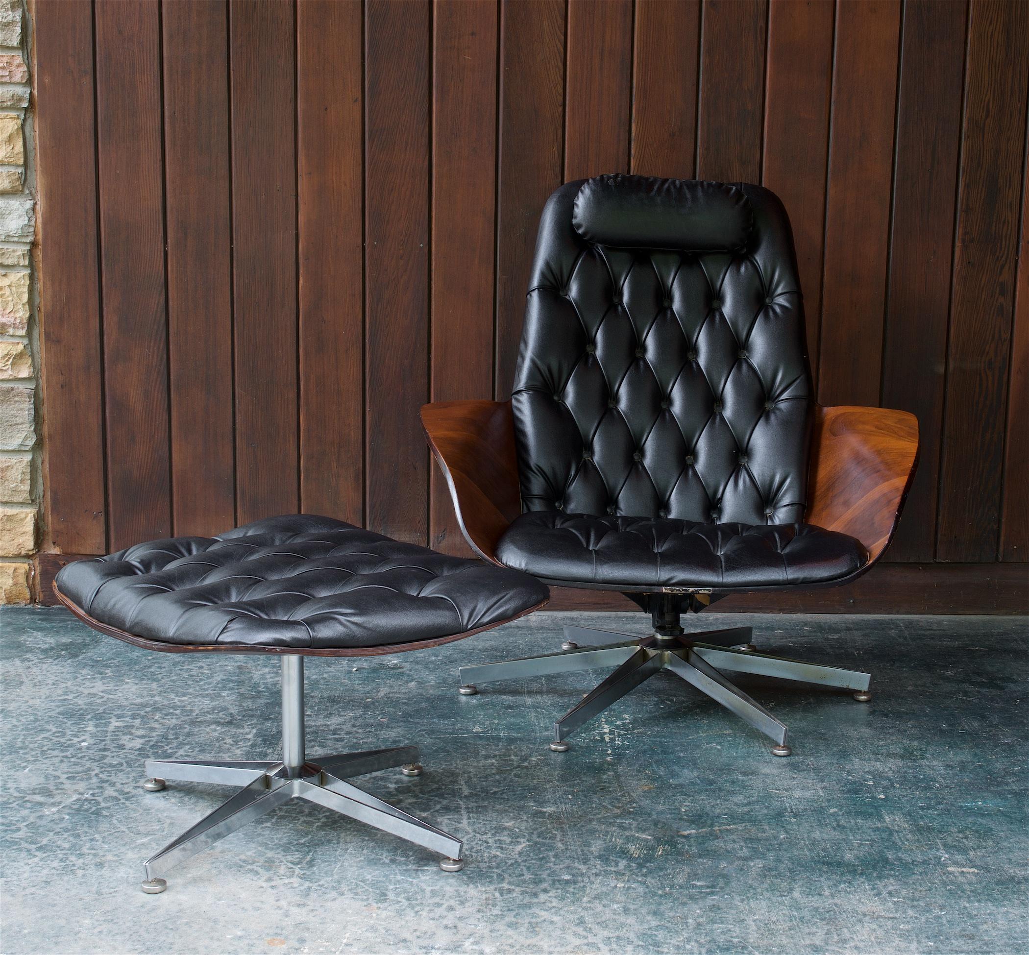 USA, c.1960s. Mr. Chair, a molded plywood lounge chair & ottoman by Plycraft designed by George Mulhauser, Walnut w/ Original Black Vinyl Upholstery, made in the USA.  Fair vintage condition. Chair has a slight lean but functions