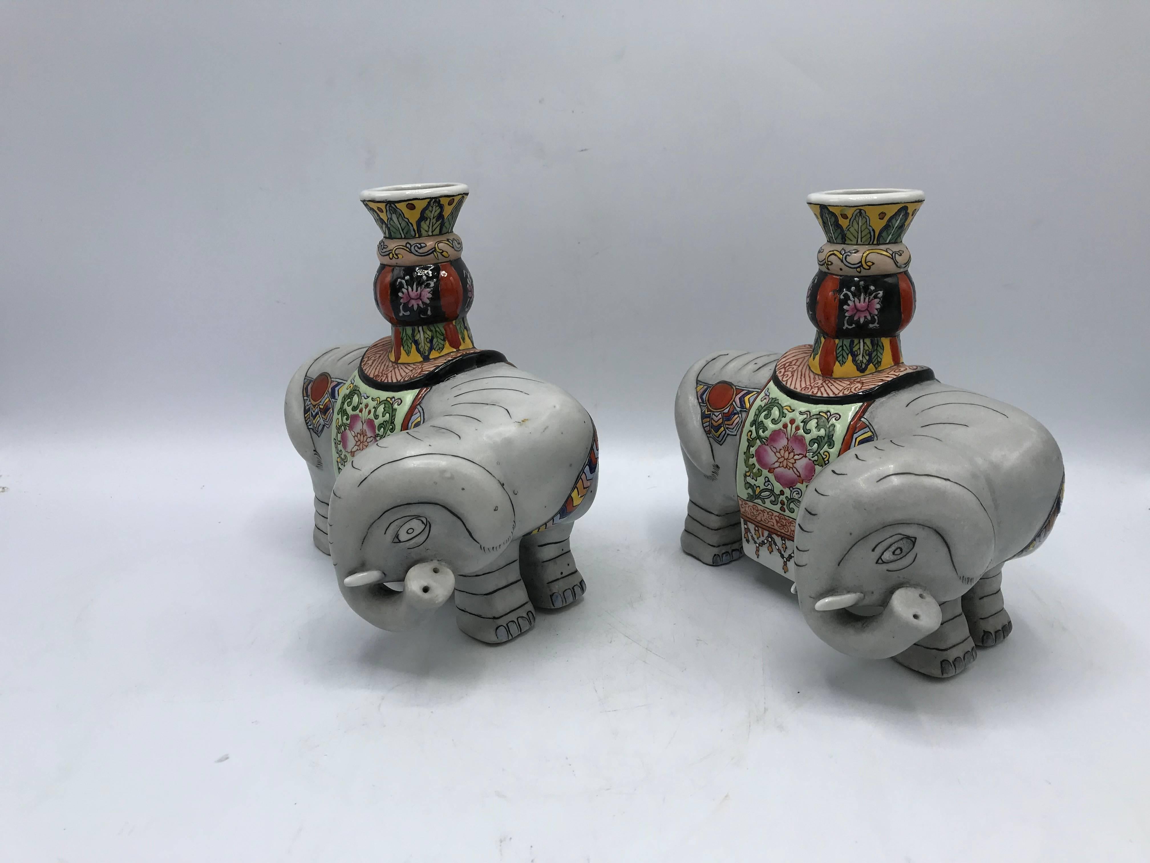 Offered is a gorgeous and fun, pair of 1960s polychrome ceramic elephant sculpture candlestick holders. Heavy,
