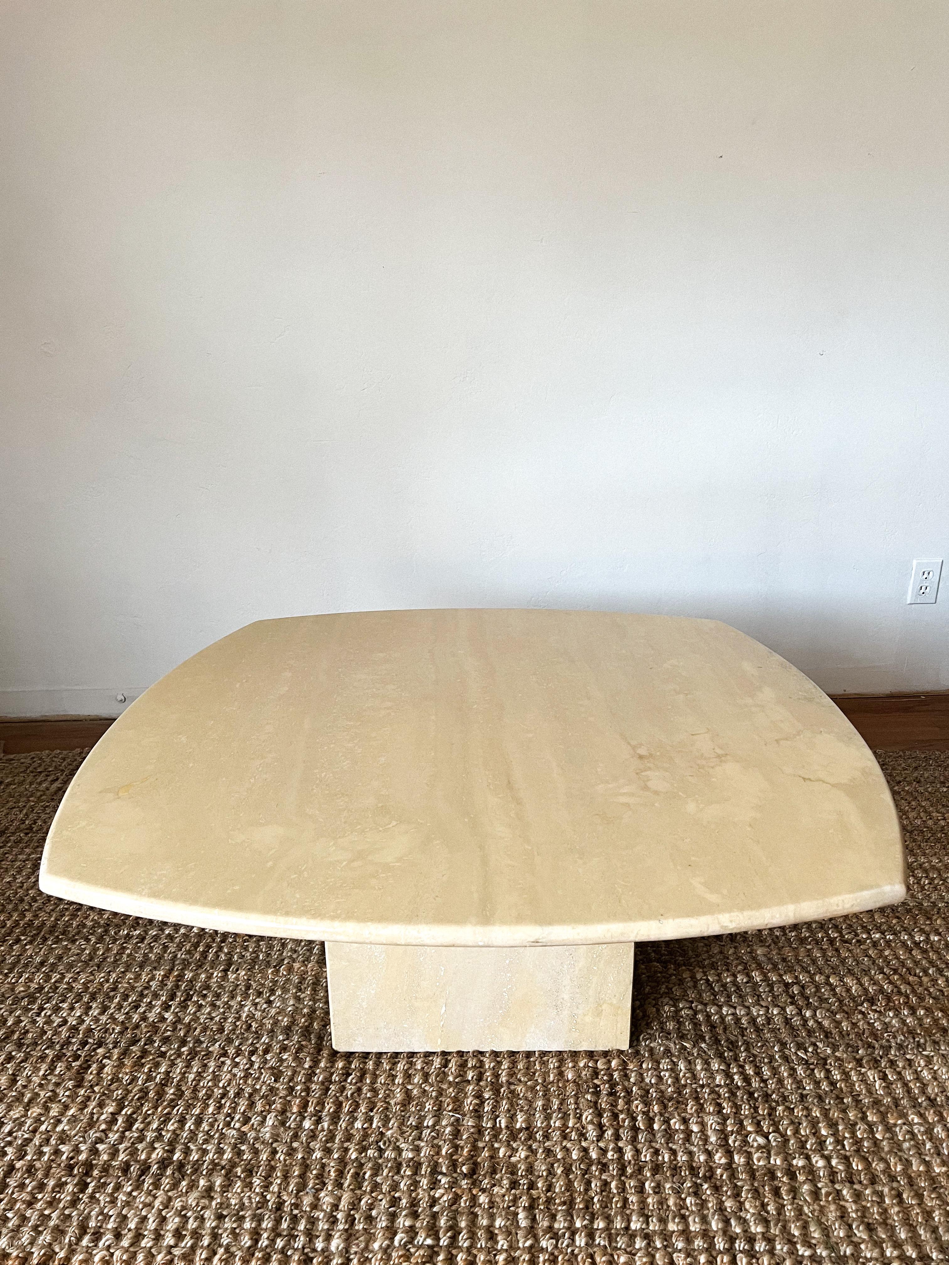 A mid century modern square polished Italian travertine coffee table with rounded edges. Table is polished and features a clean edge. Very postmodern and minimalist.