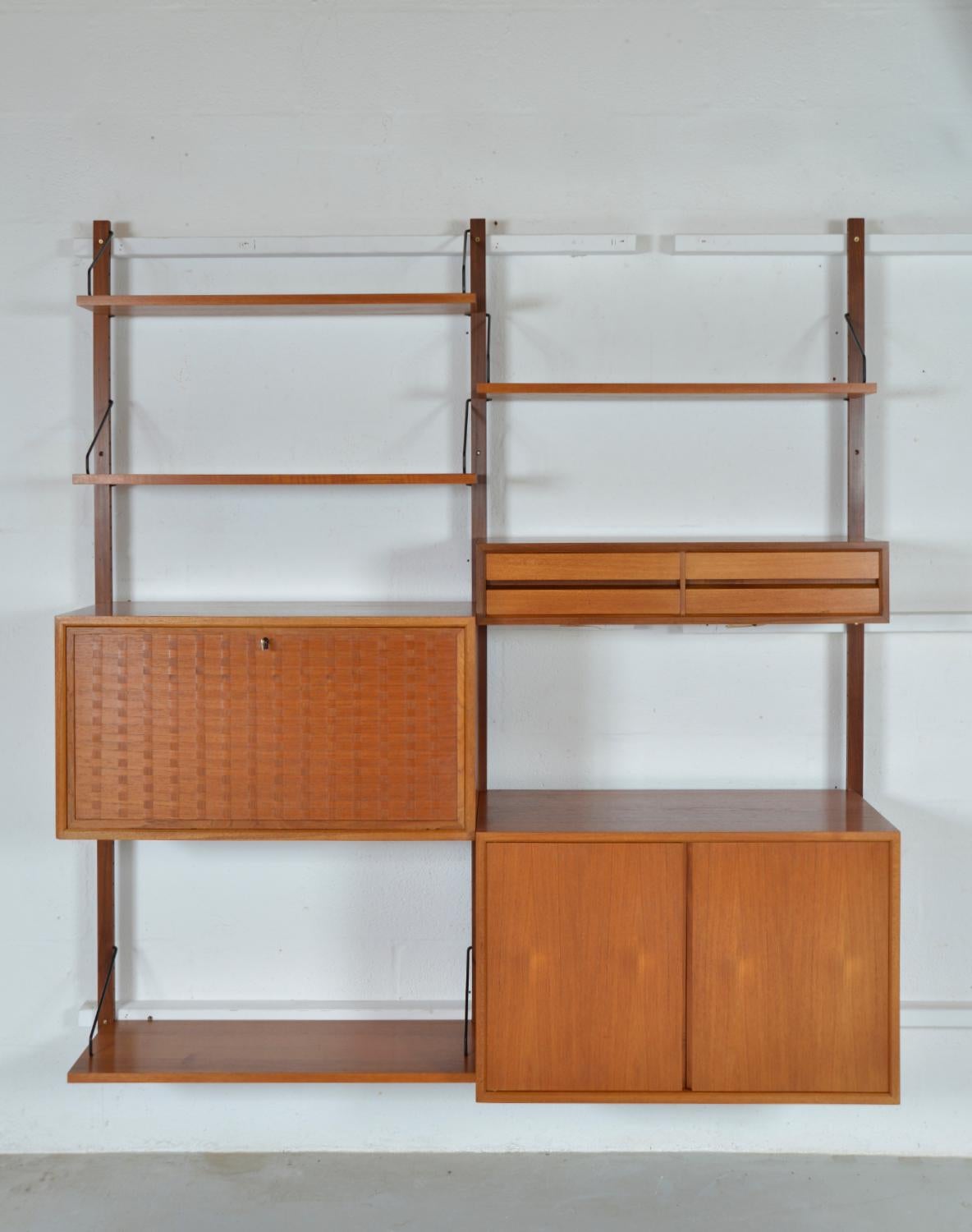 This highly versatile and functional “Royal System” was originally designed by Poul Cadovius in 1948. This useful two-bay teak shelving system offers a variety of storage and display options, which can be configured to your choice. The set includes