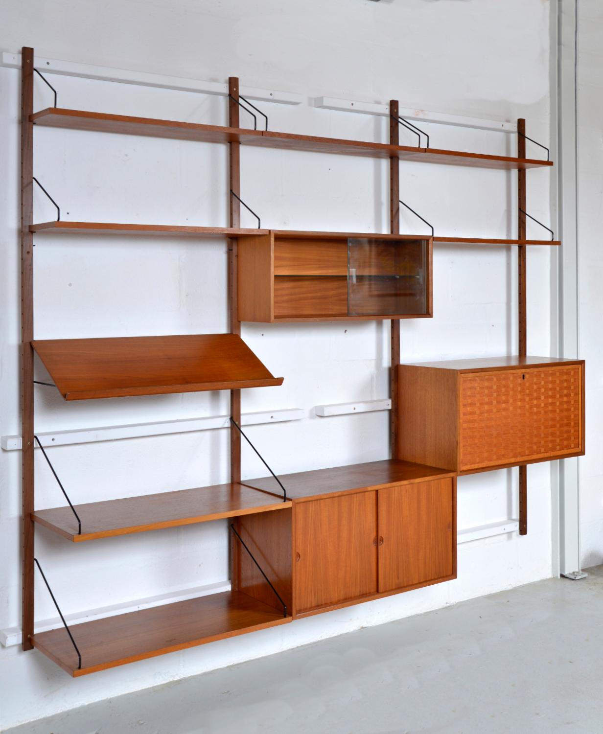 This highly versatile and functional “Royal System” was originally designed by Poul Cadovius in 1948. This three-bay teak shelving system offers a wide variety of storage and display options. The set includes a very attractive basket weave lockable