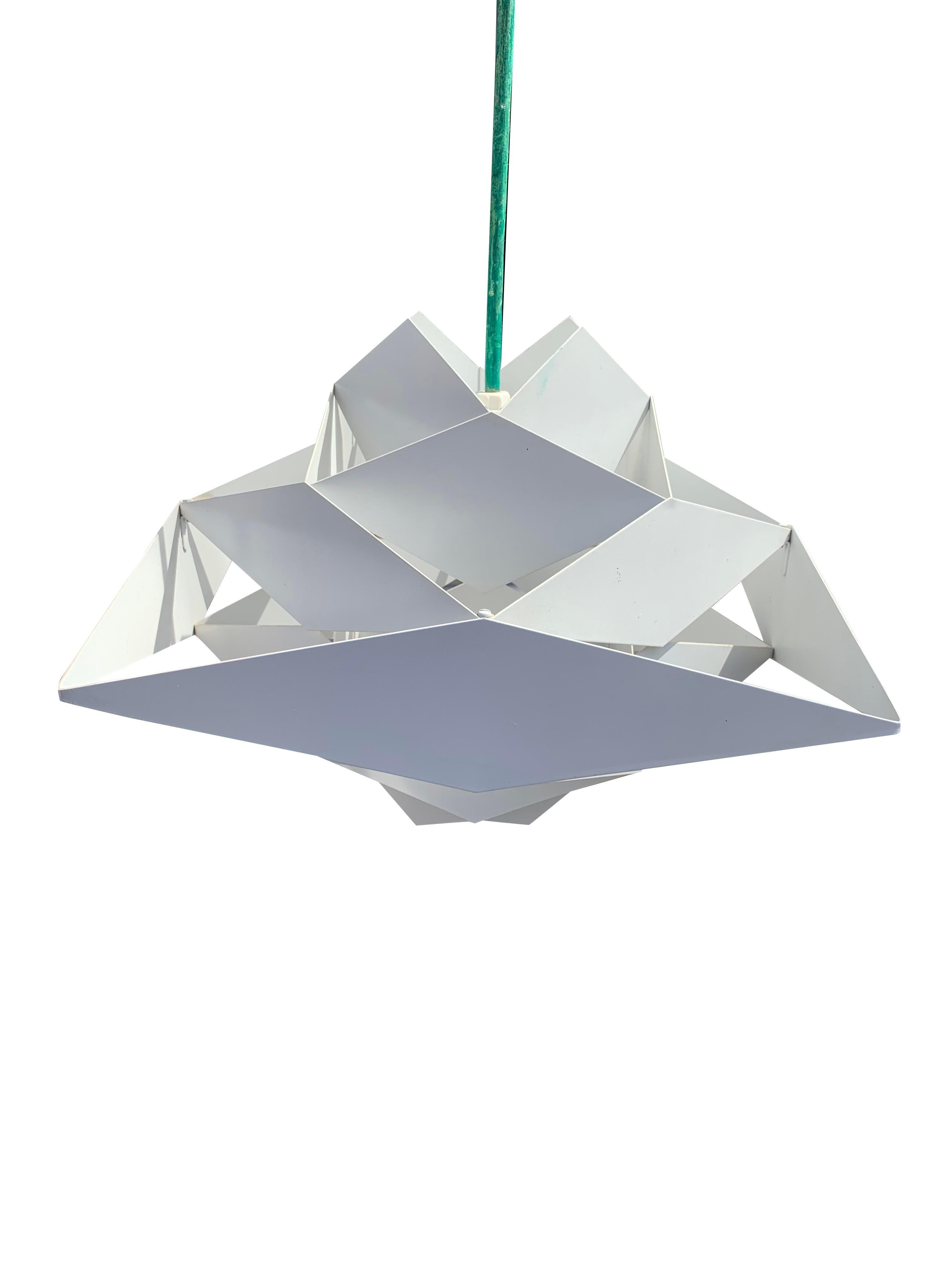 Vintage Danish Preben Dahl Symfoni Hanging Lamp

Designed by the renowned Preben Dahl, this piece showcases a captivating blend of geometry and enameled steel. The lamp's intricate geometric patterns and striking enameled finish create a captivating