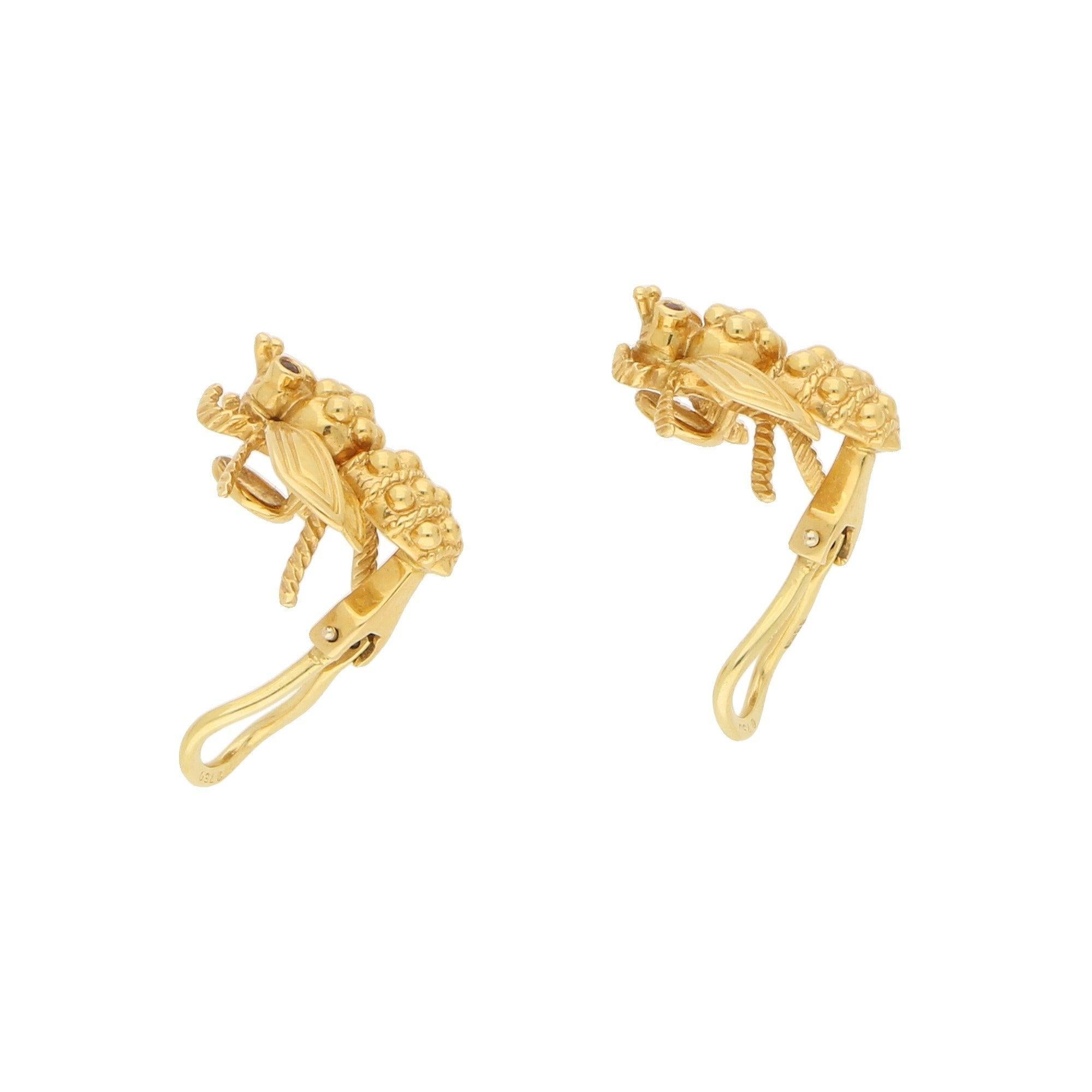 A lovely pair of vintage Tiffany & Co. ruby-eyed queen bee earrings in 18-karat yellow gold, circa 1960. Each earring is designed as a stylized queen bee in yellow gold, the body composed of gold beads within ropework detailing, the textured head