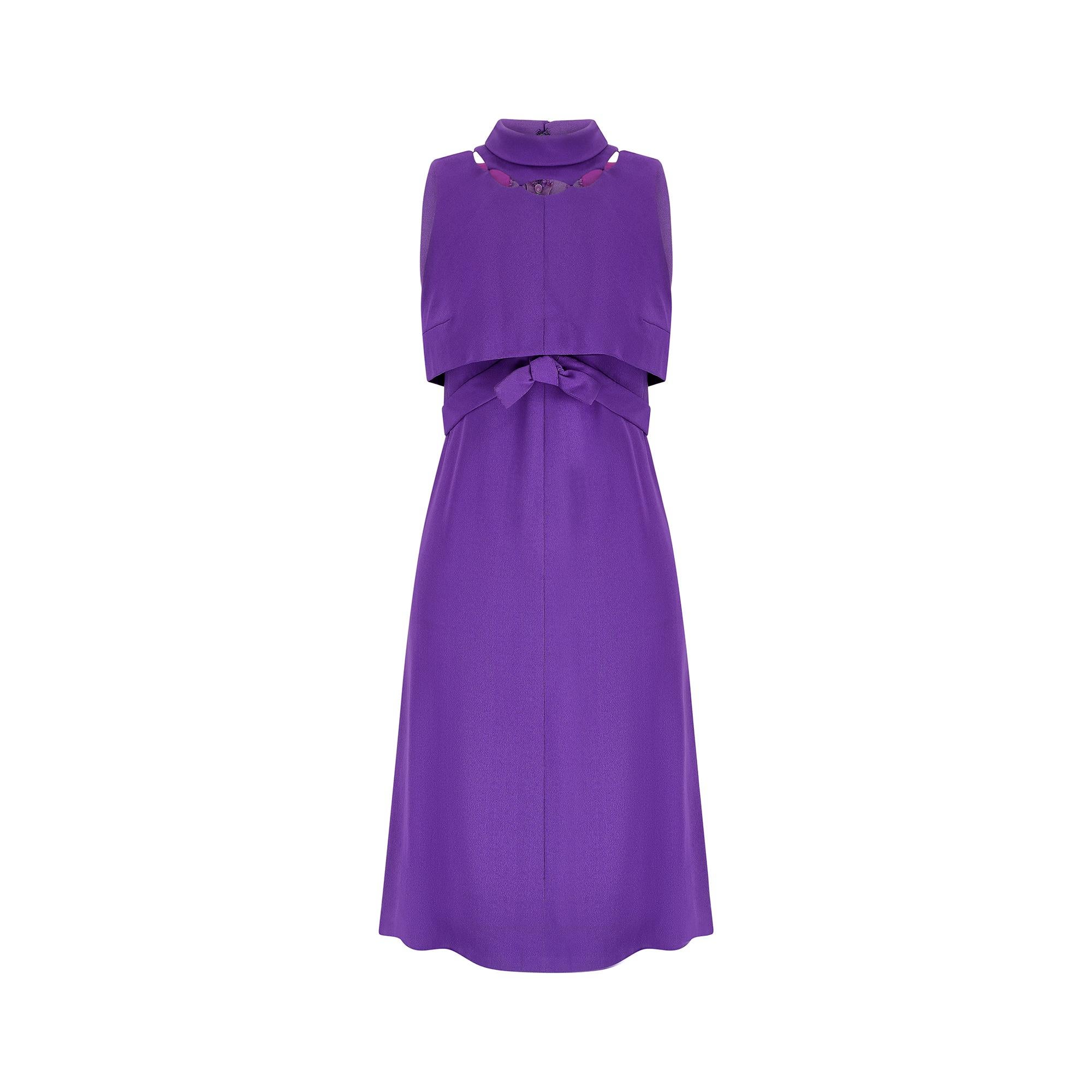 Cut from vibrant purple crepe, this exceptional 1960s dress is by Royal British couturiers - Rahvis.  Founded as a couture salon, “Rahvis Gowns”, in 1929, it was one of very few female-lead labels at this time. Run by two sisters, Raemonde and Dora,