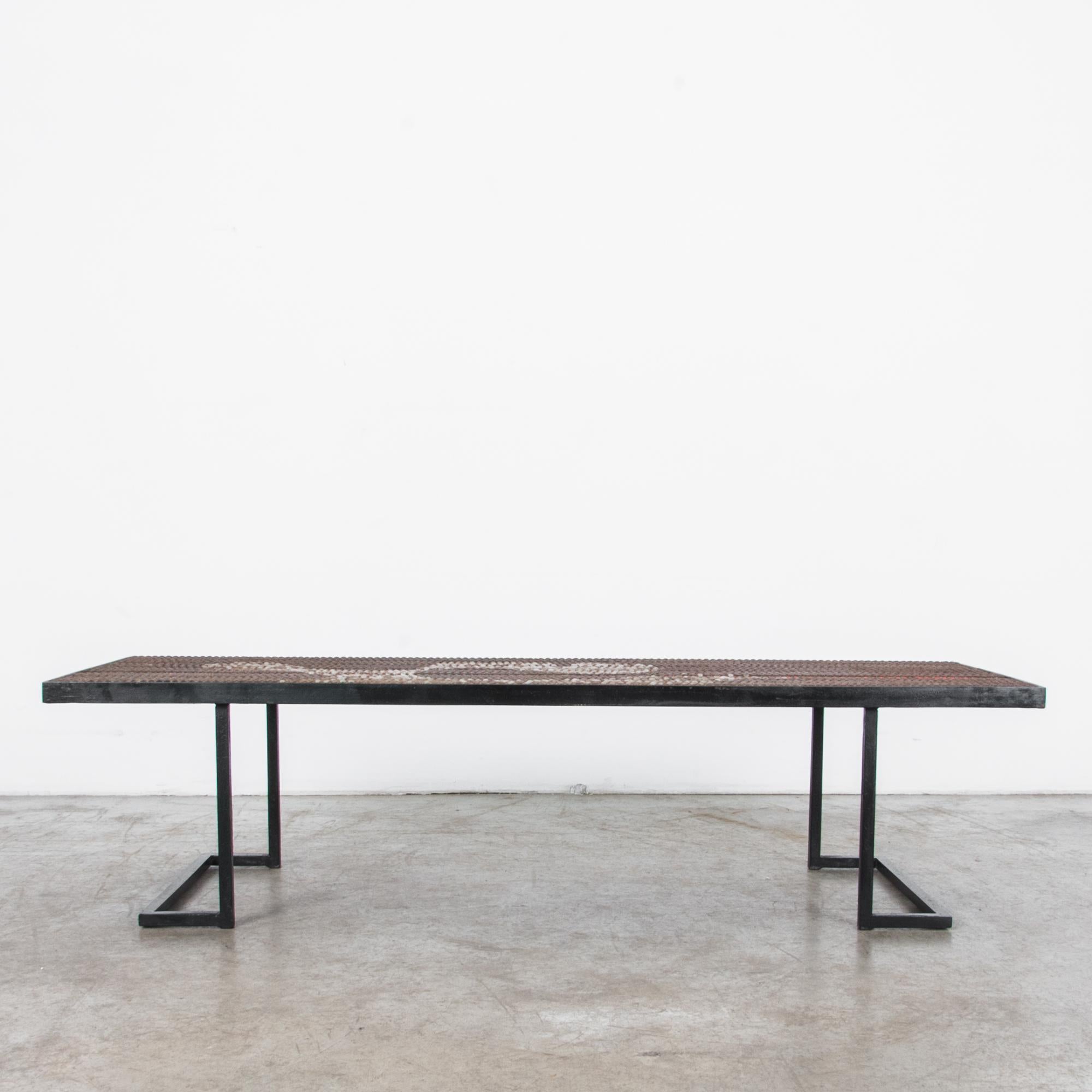 A rare 1960s table from Europe, featuring a geometric metal frame and an original tabletop design. Raised metal pins on the surface of the tabletop coalesce into a flowing, abstract pattern, punctuated by lines of red paint, while the black metal