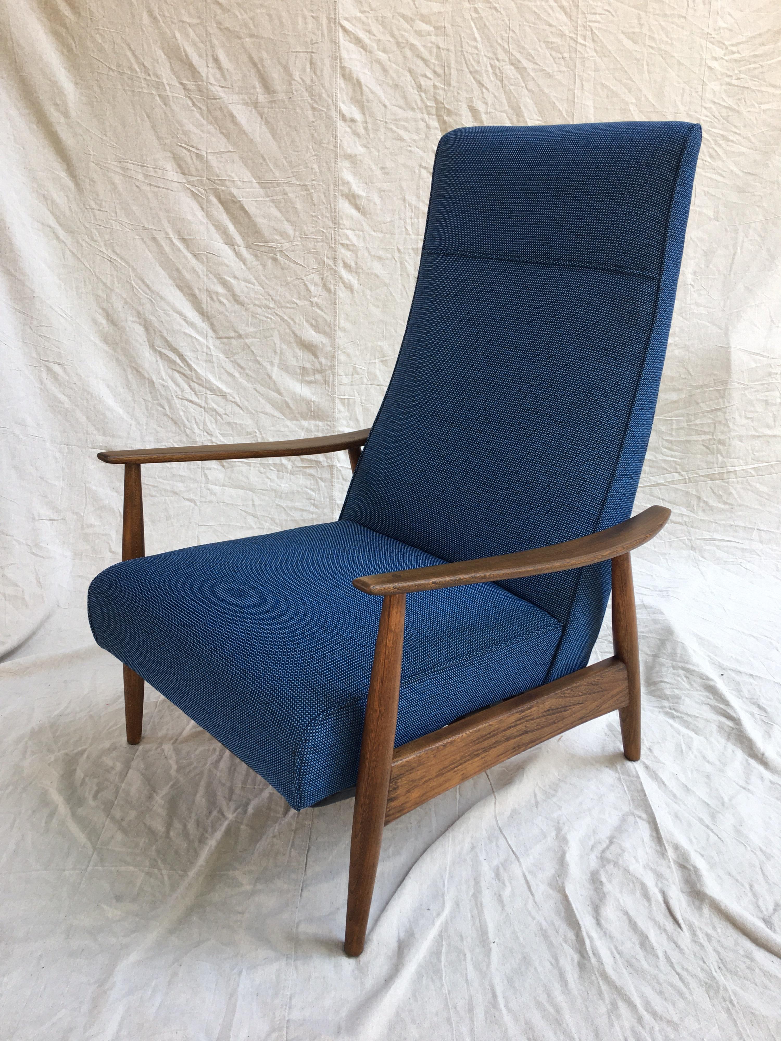 1960s recliner in the style of Milo Baughman. footrest kicks out when you lean back! Black leather and a really nice nubby blue fabric. Walnut Frame all refinished and ready to go! When fully extended the chair is 52