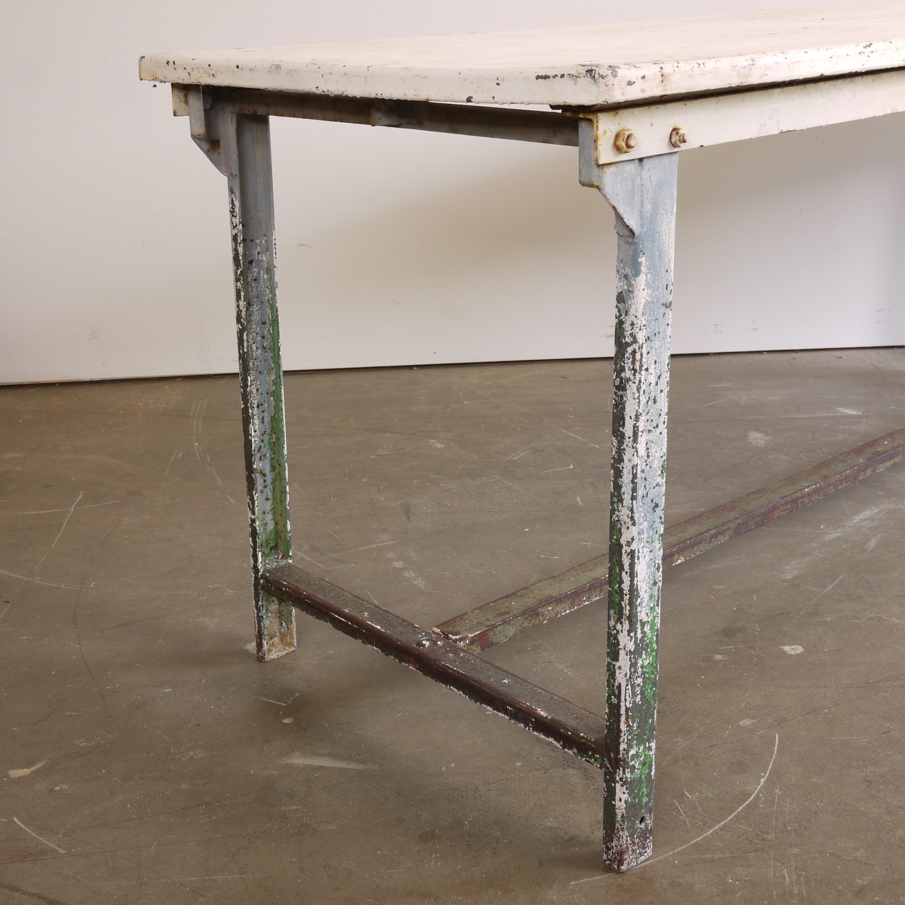 1960s vintage rectangular industrial white metal dining, statement table. A weathered industrial metal table sourced from the South of France still retaining its original weathered white painted finish just oozing character and patina. The panelled
