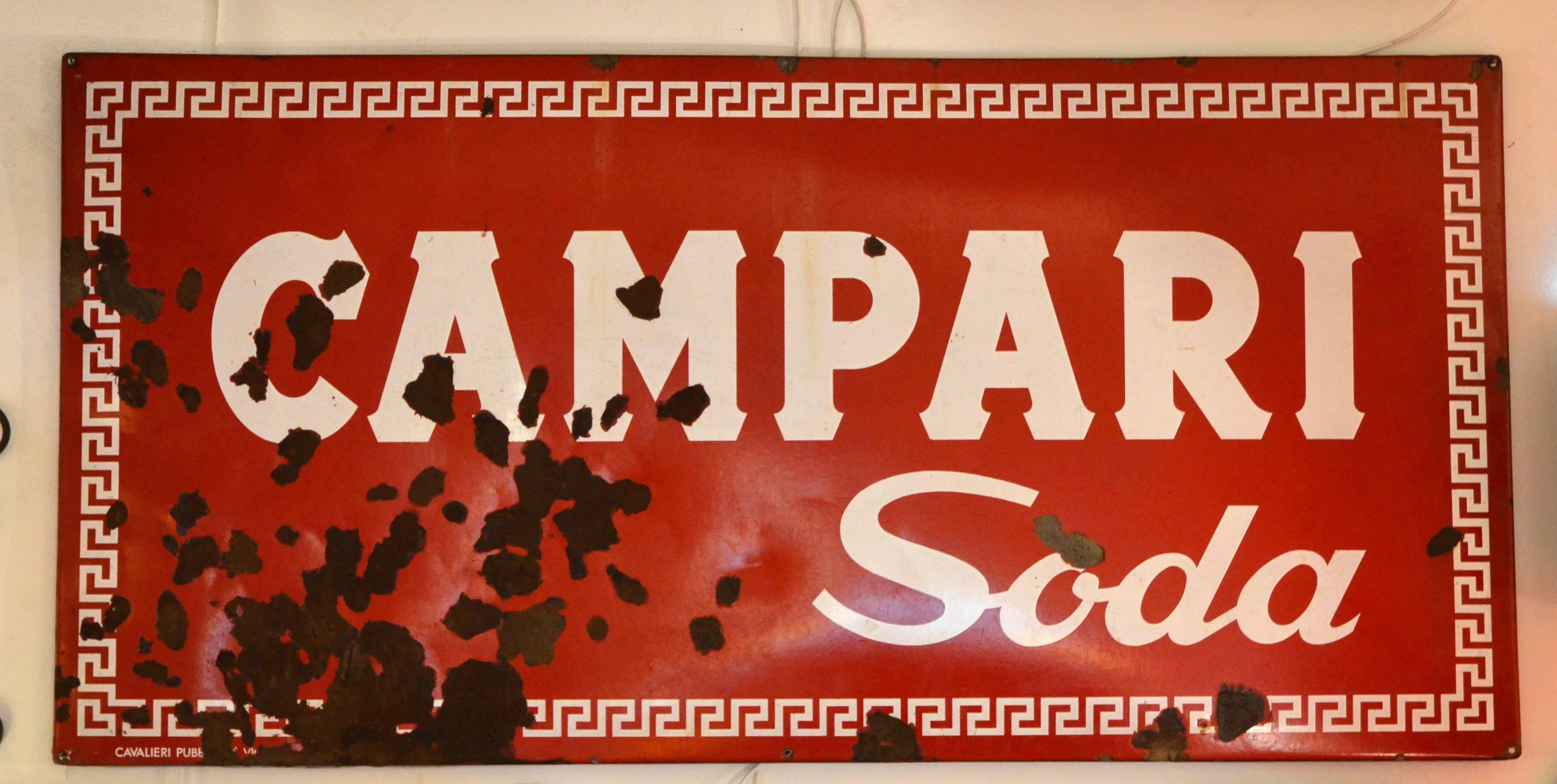 This large enamel metal sign of Campari Soda was produced in the 1960s by
Cavalieri Pubblicità in Vicenza, Italy.
Cavalieri Pubblicità produced three different type of large enamel metal sign for Campari: Bitter Campari, Campari Soda or a plane